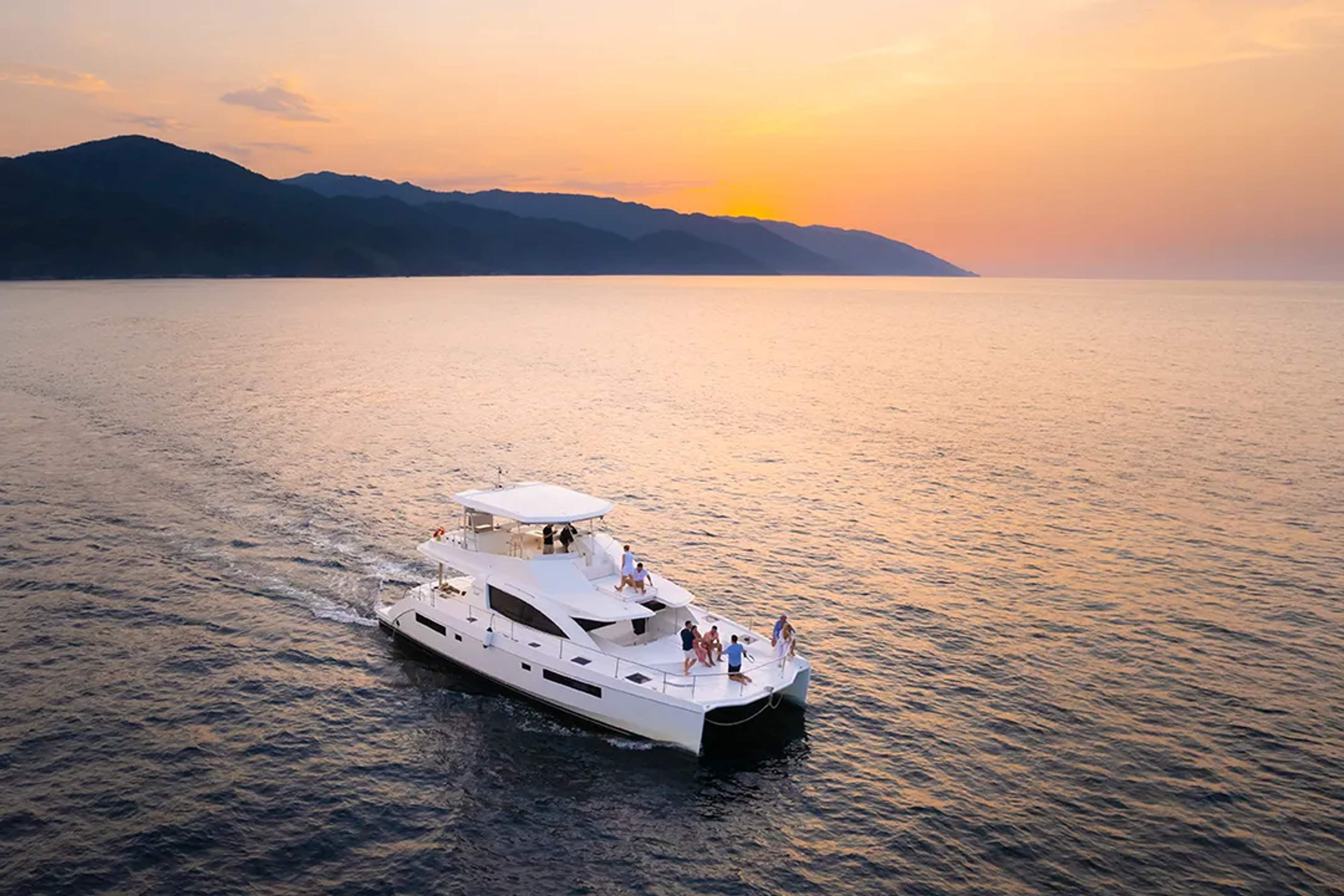 Luxury catamaran sunset cruise in Puerto Vallarta sailing across Banderas Bay with mountain views