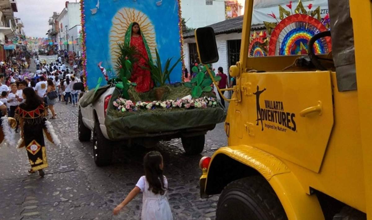 December pilgrimage with people celebrating the Virgin of Guadalupe in Mexico, featuring a decorated float and traditional attire.