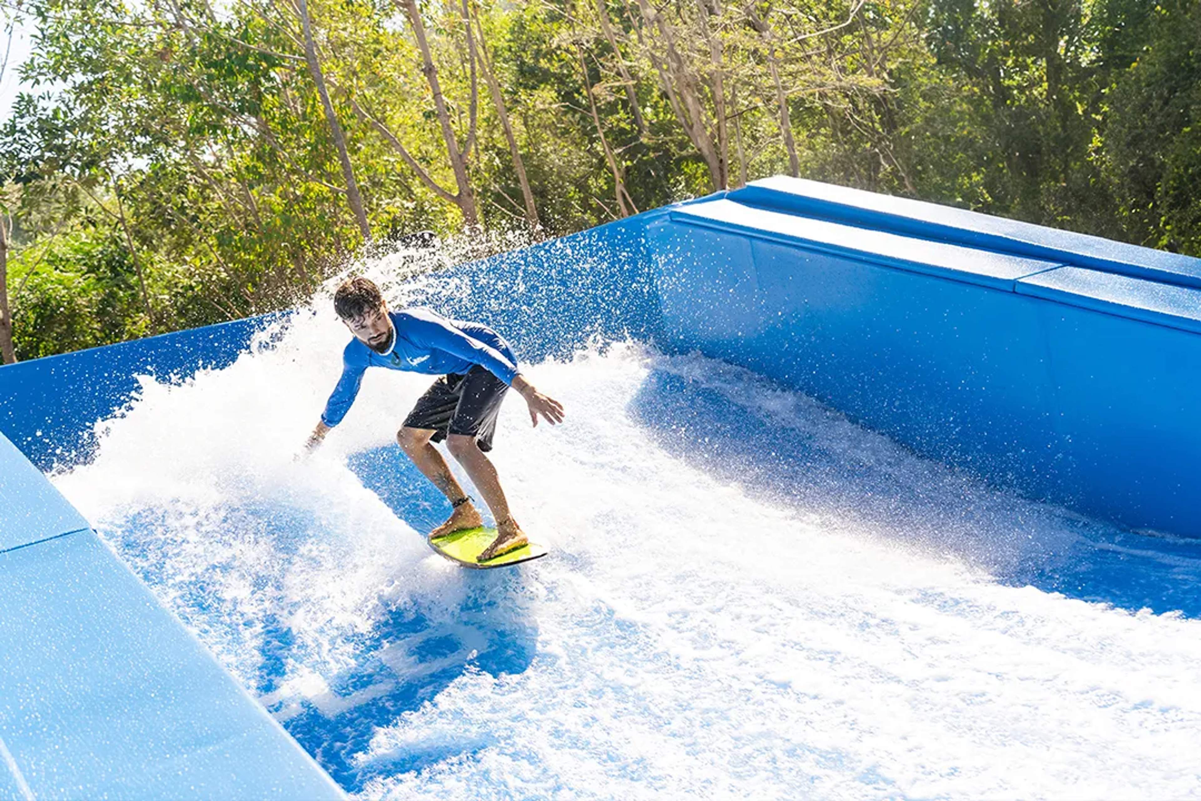 FlowRider surf experience in Cabo San Lucas, riding continuous waves at an adventure park surrounded by nature