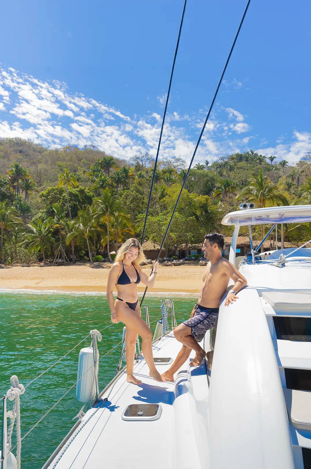 Pareja relajándose en un catamarán anclado frente a la playa Majahuitas.