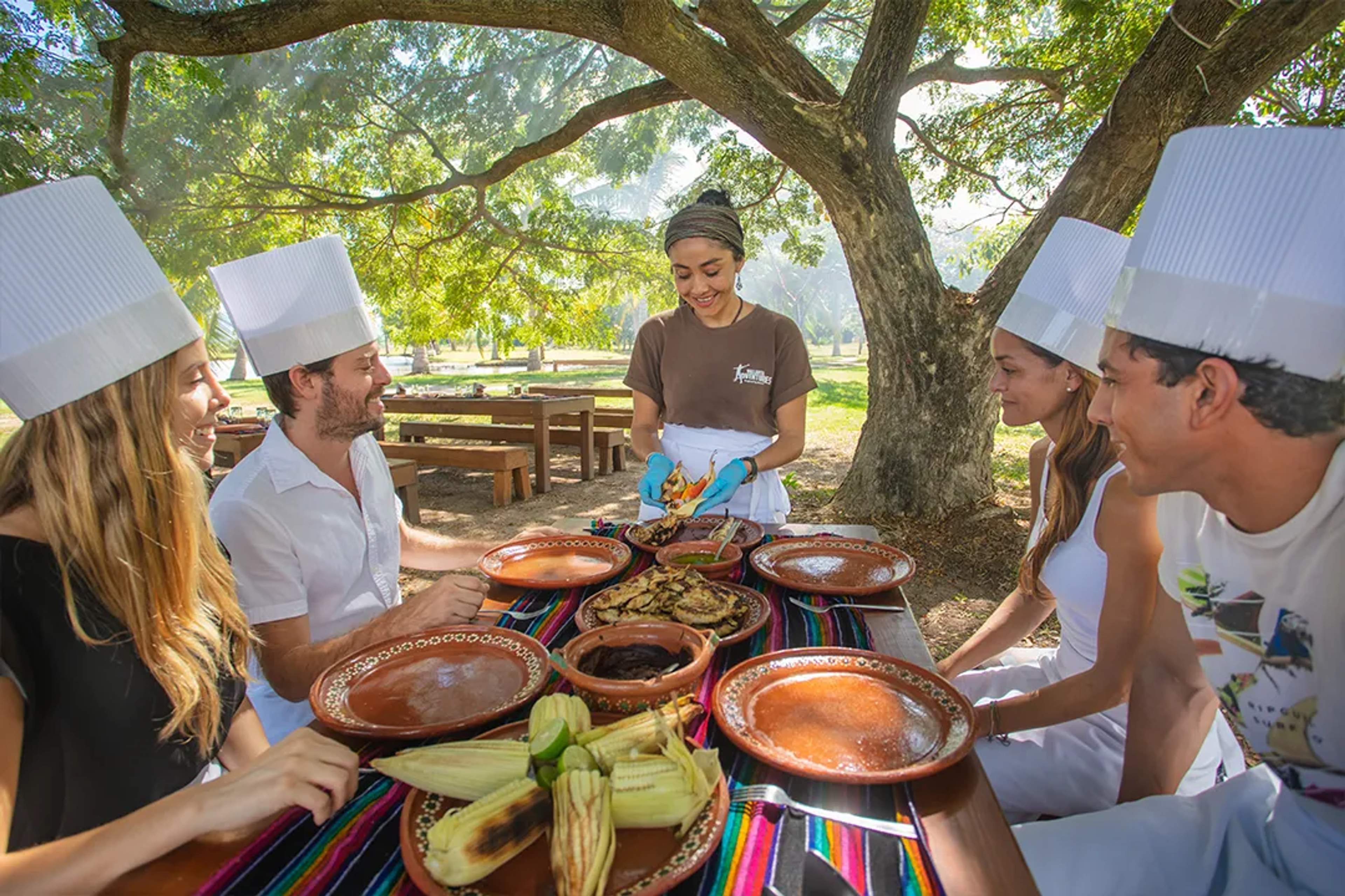 Guests learning traditional Mexican cooking in Puerto Vallarta outdoor culinary experience with local flavors