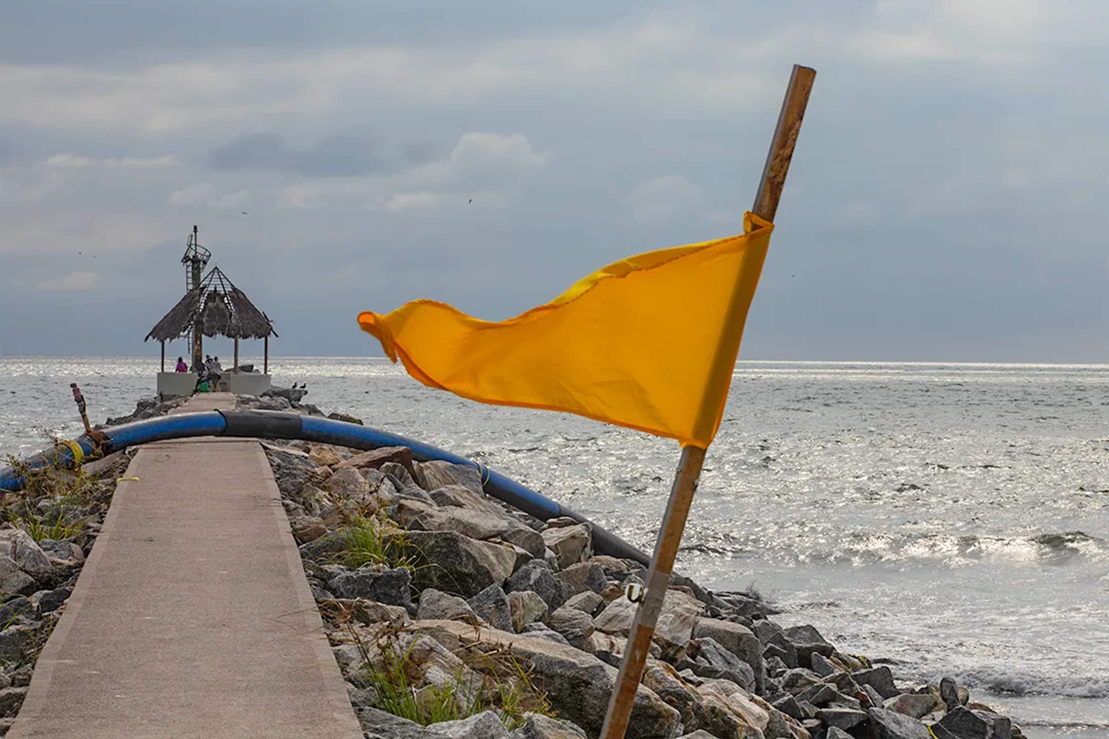 Yellow flag warning on Puerto Vallarta beach signaling moderate surf and caution in ocean conditions