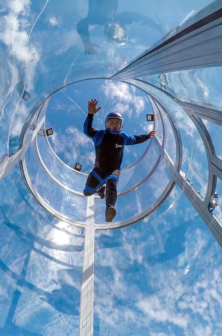 Young man flying in a thrilling skydiving simulator on the Extreme Adventure tour in Puerto Vallarta.