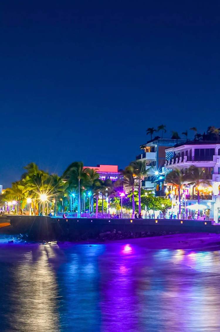 View of the Puerto Vallarta malecon at night from the sea.