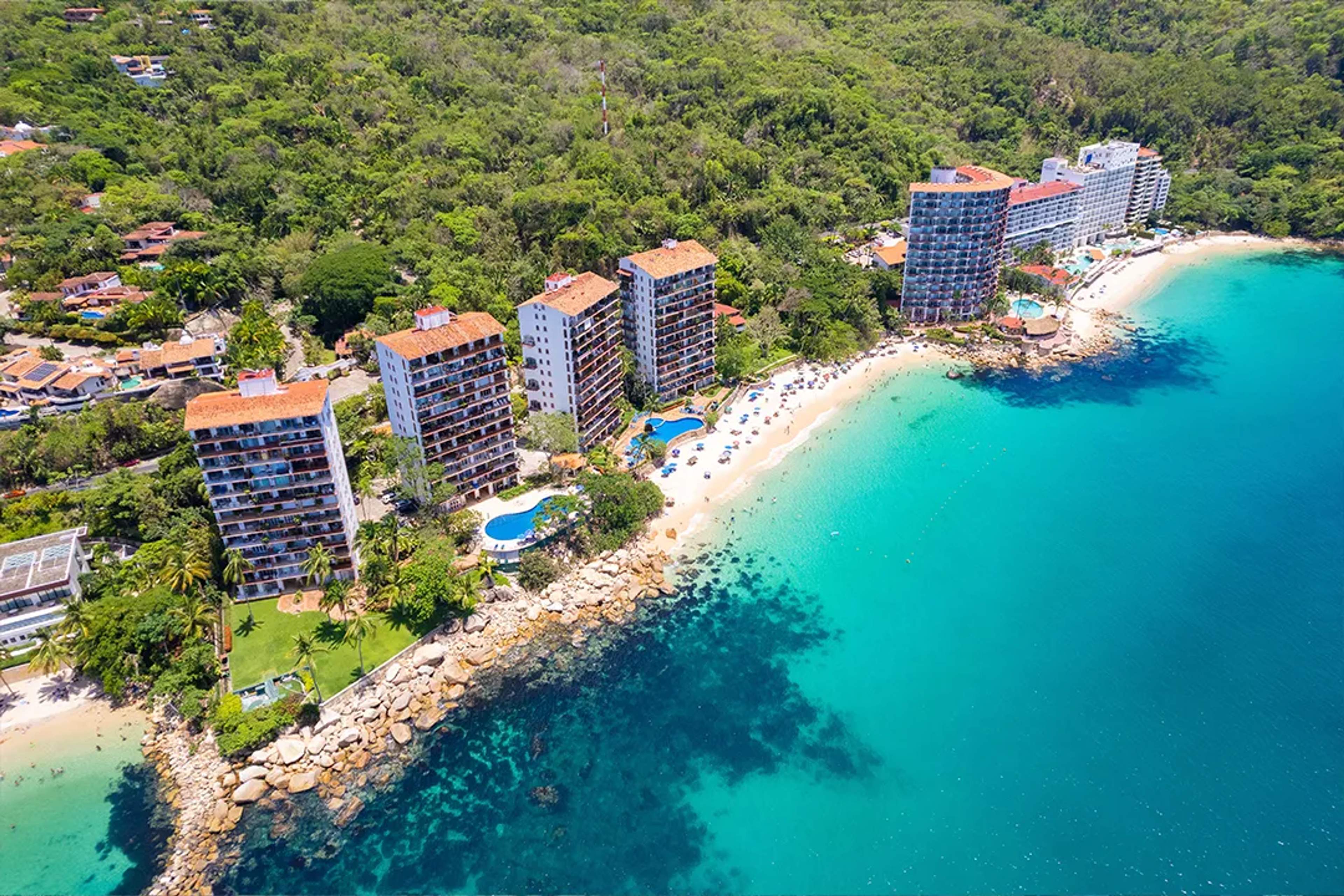Aerial view of Playa Las Gemelas in Puerto Vallarta with turquoise water and beachfront resorts.