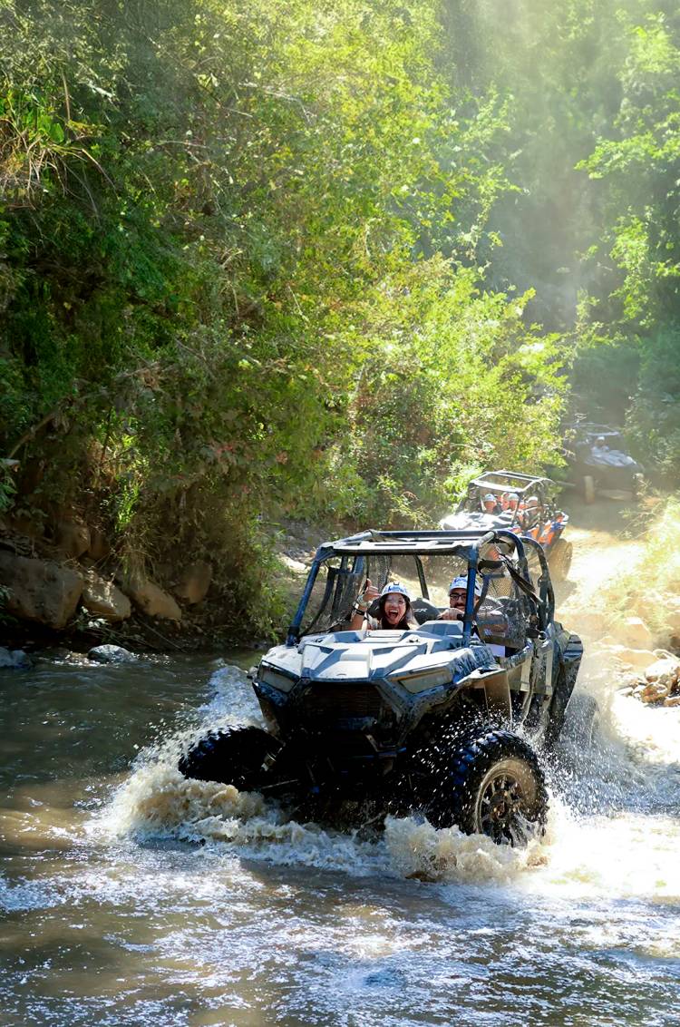 Puerto Vallarta ATV tour crossing a creek as part of a exciting Tour Package.