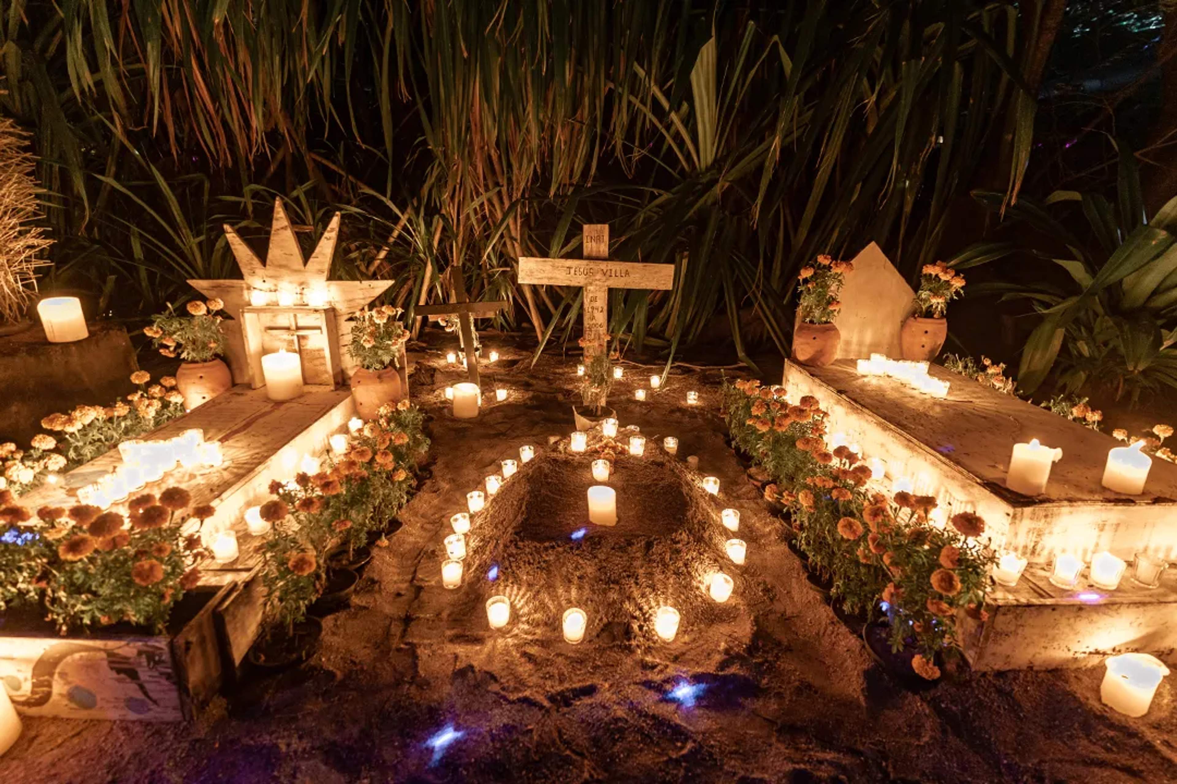 Traditional Day of the Dead altar illuminated by candles and marigolds during a cultural celebration in Mexico