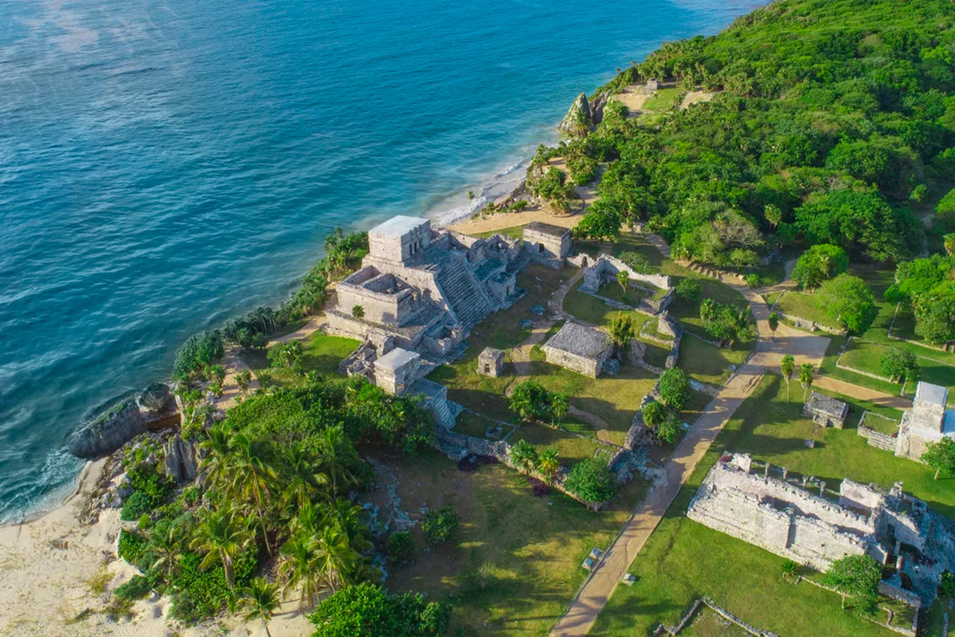 Aerial view of Tulum’s Mayan ruins by the Caribbean Sea, showcasing the iconic cliffside temple.