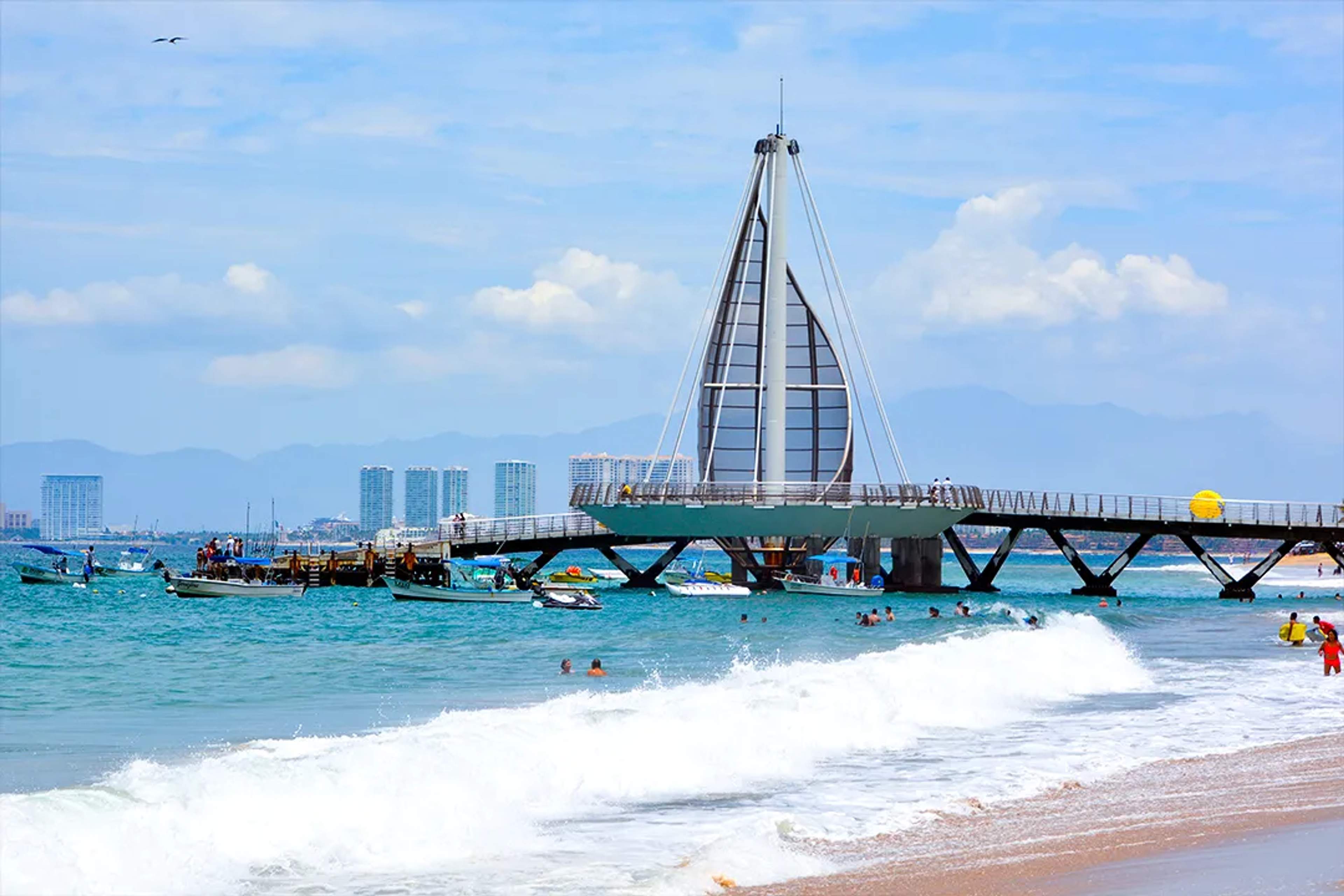 Los Muertos Pier in Puerto Vallarta, iconic beach landmark and Banderas Bay coastal view.
