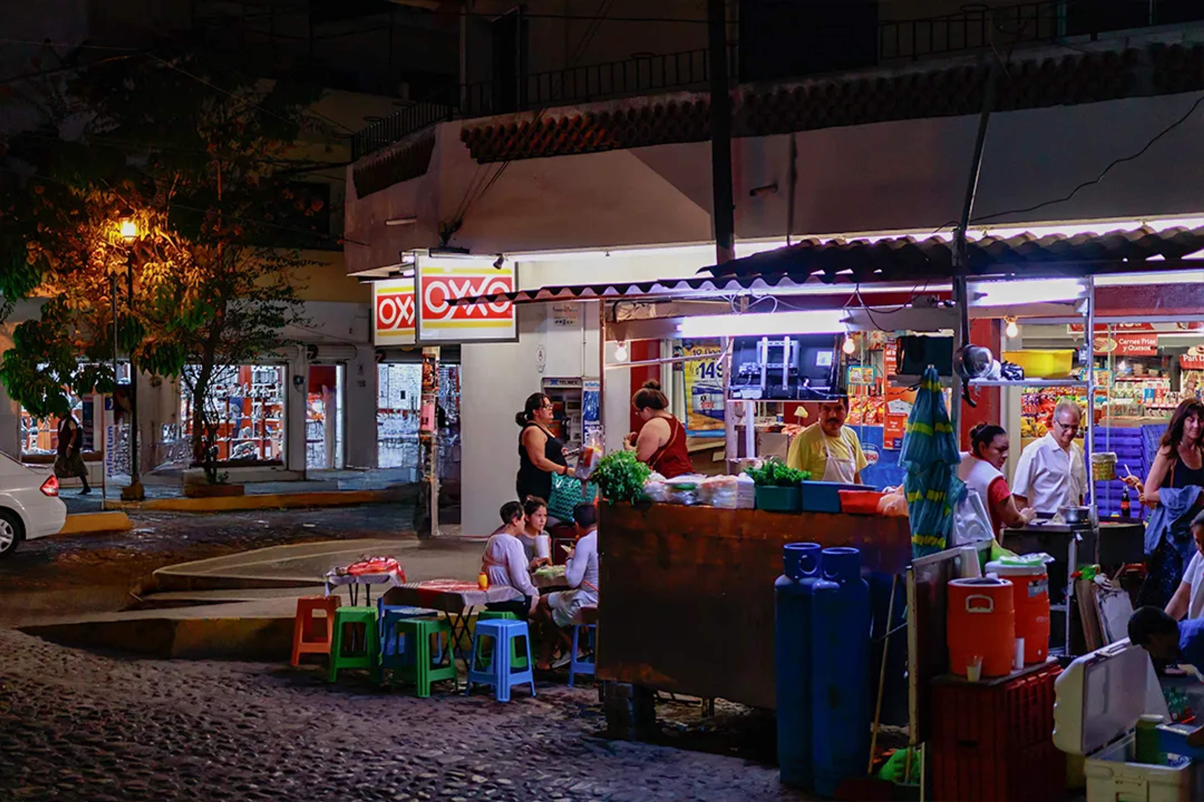 Night street taco stand in Puerto Vallarta, authentic Mexican food and local culinary tour.