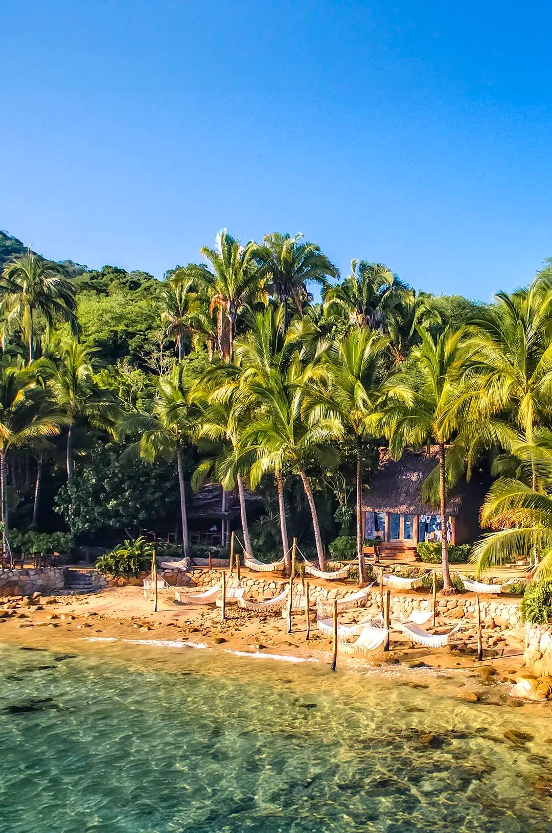 Beautiful view of Las Caletas beach with its iconic hammocks over the waves.