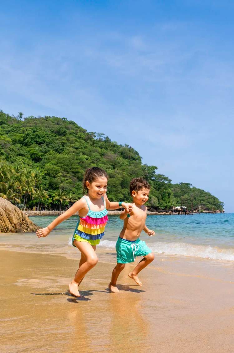 Children playing on the sand at Caletas beach Puerto Vallarta.