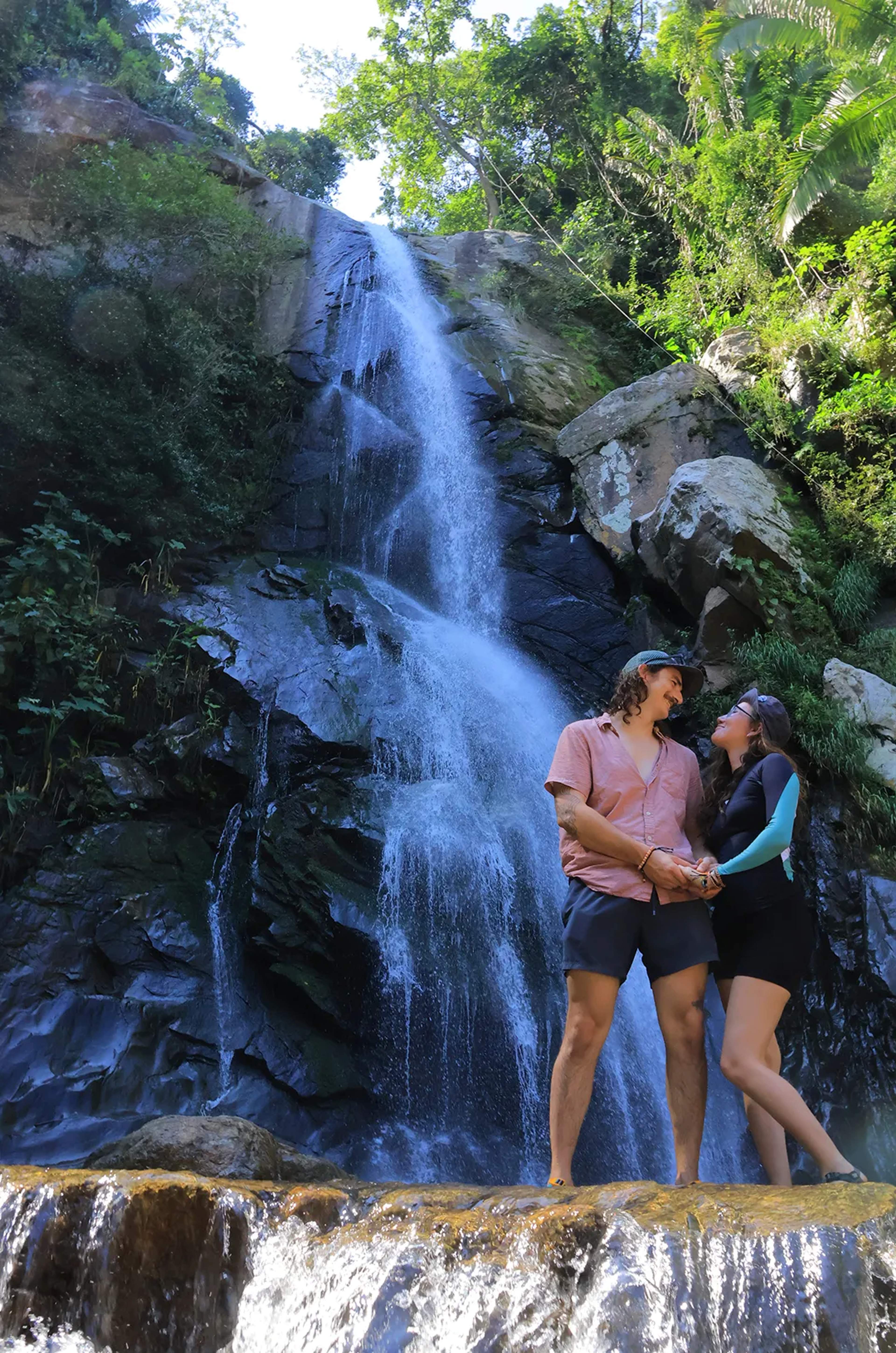 Couple standing at Upper Yelapa Waterfall, a hidden jungle cascade near Puerto Vallarta surrounded by lush rainforest