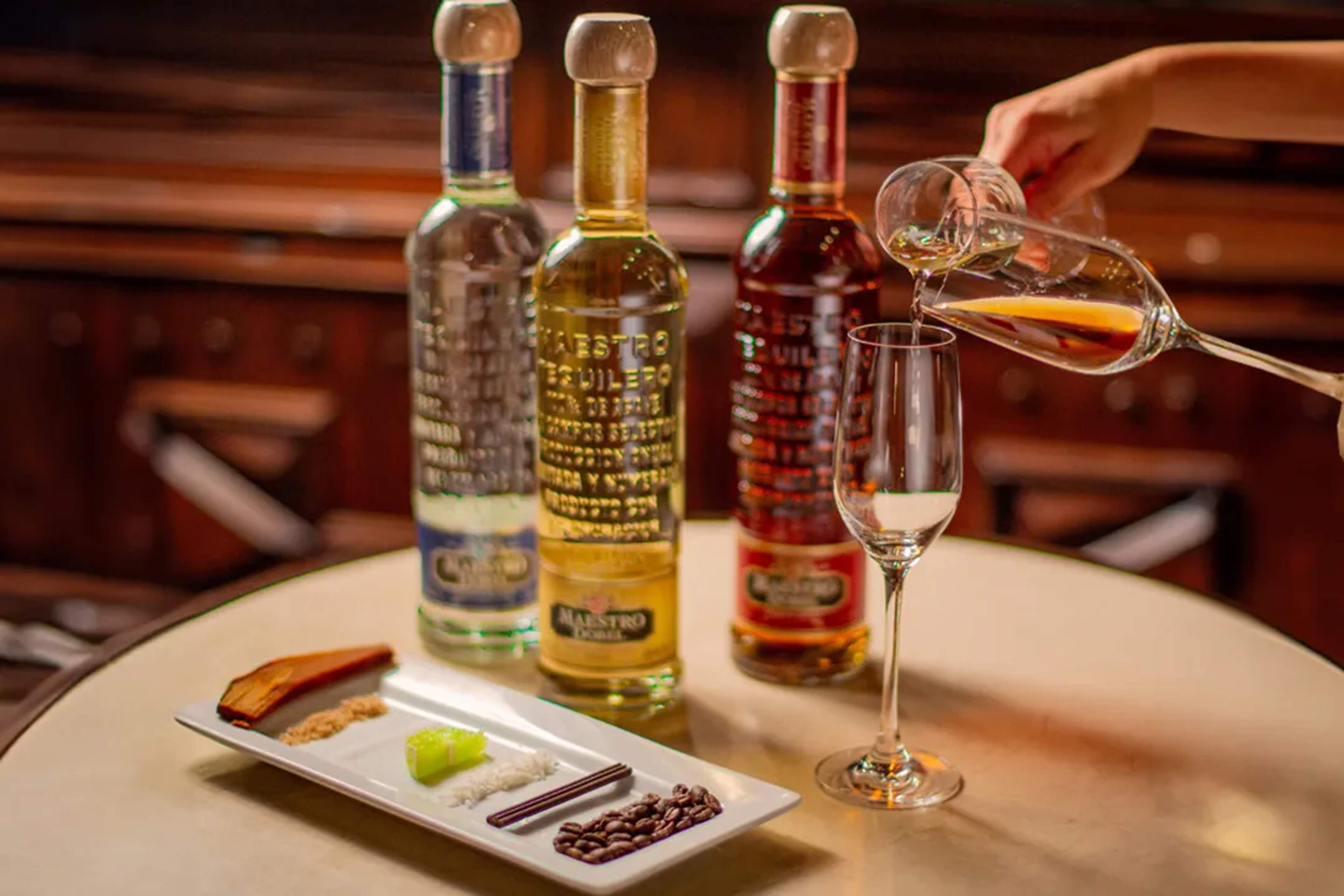 Tequila tasting with Maestro bottles, paired with lime, coffee, chocolate, and spices.