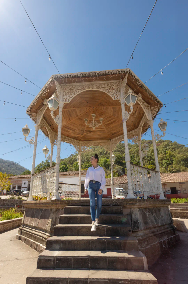Traveler admiring the charming kiosk of San Sebastian del Oeste town square.
