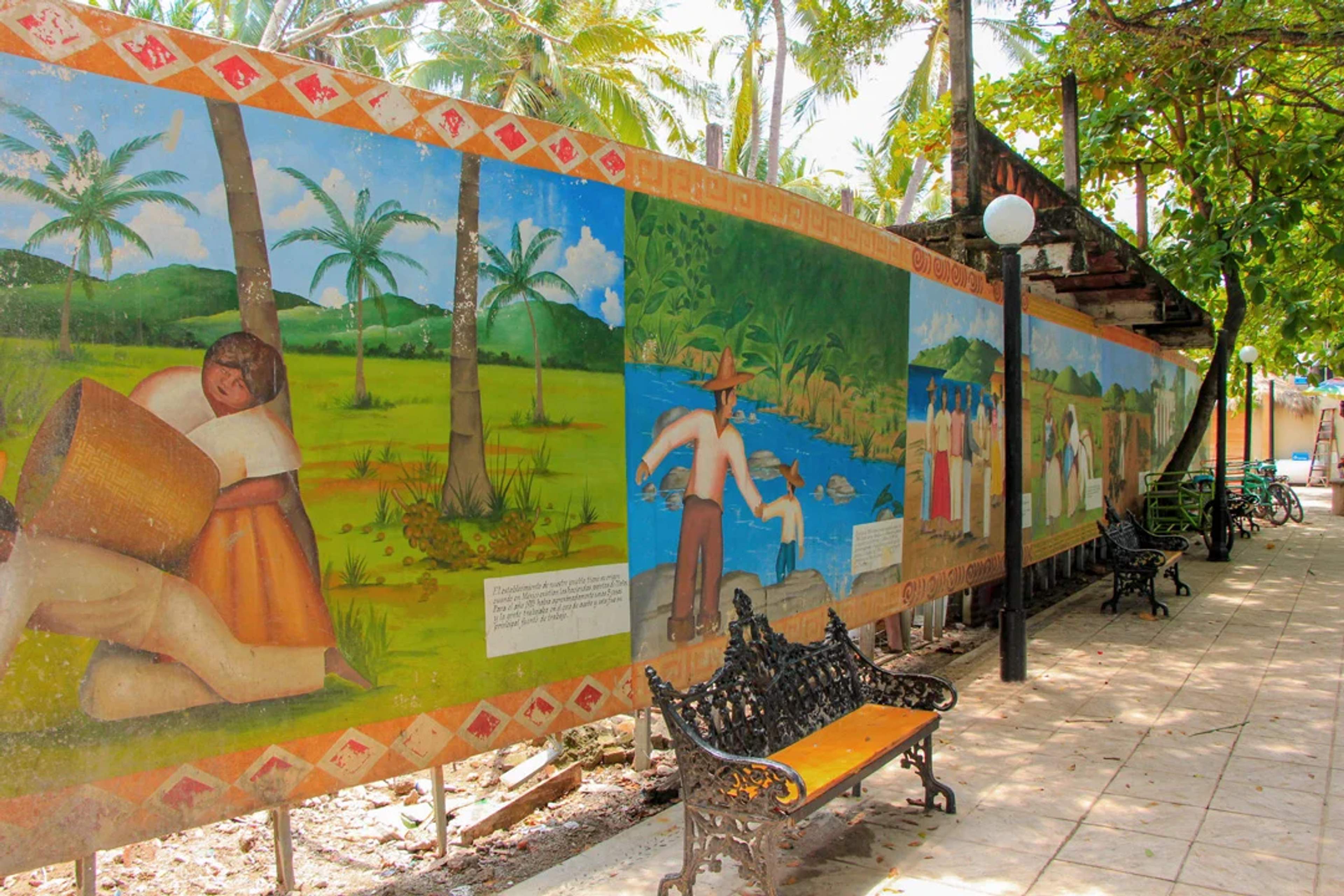 Colorful mural in San Pancho, Mexico, depicting local life and culture, perfect for experiencing the town's artistic charm.
