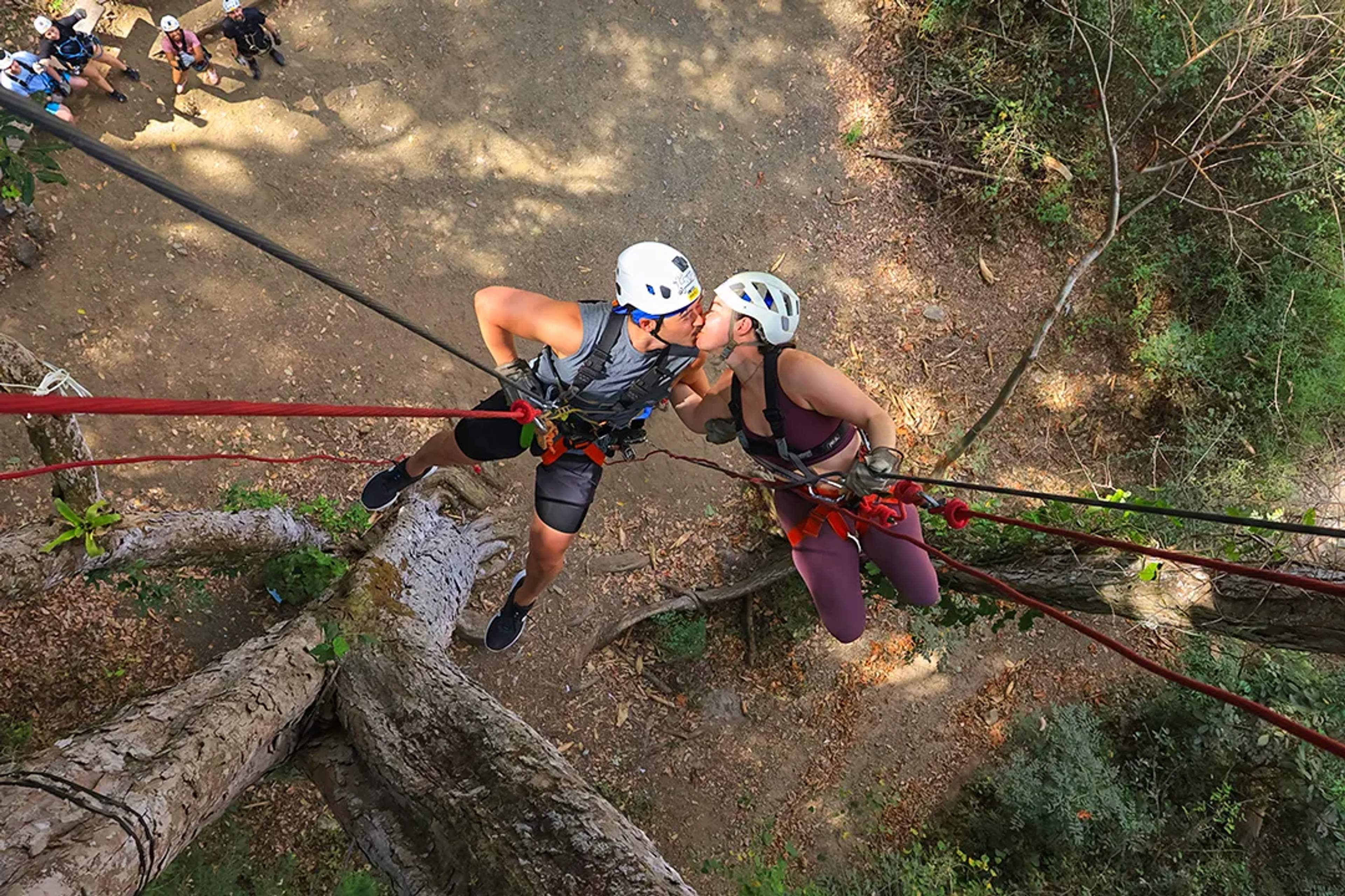 Couple rappelling in Puerto Vallarta jungle during romantic outdoor adventure tour experience