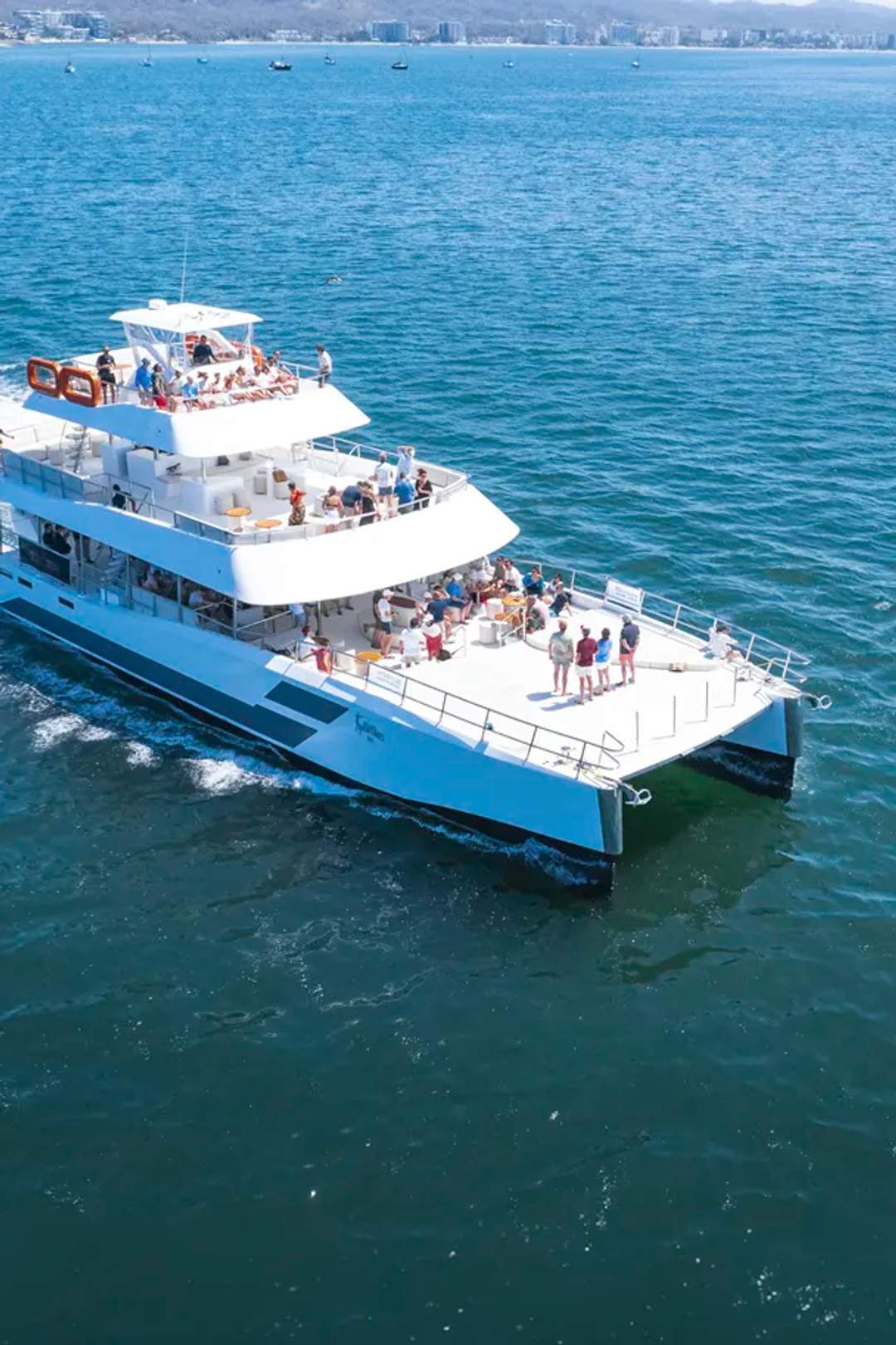Seventeen Premium Catamaran sailing Banderas Bay in Puerto Vallarta with guests enjoying its three spacious decks.