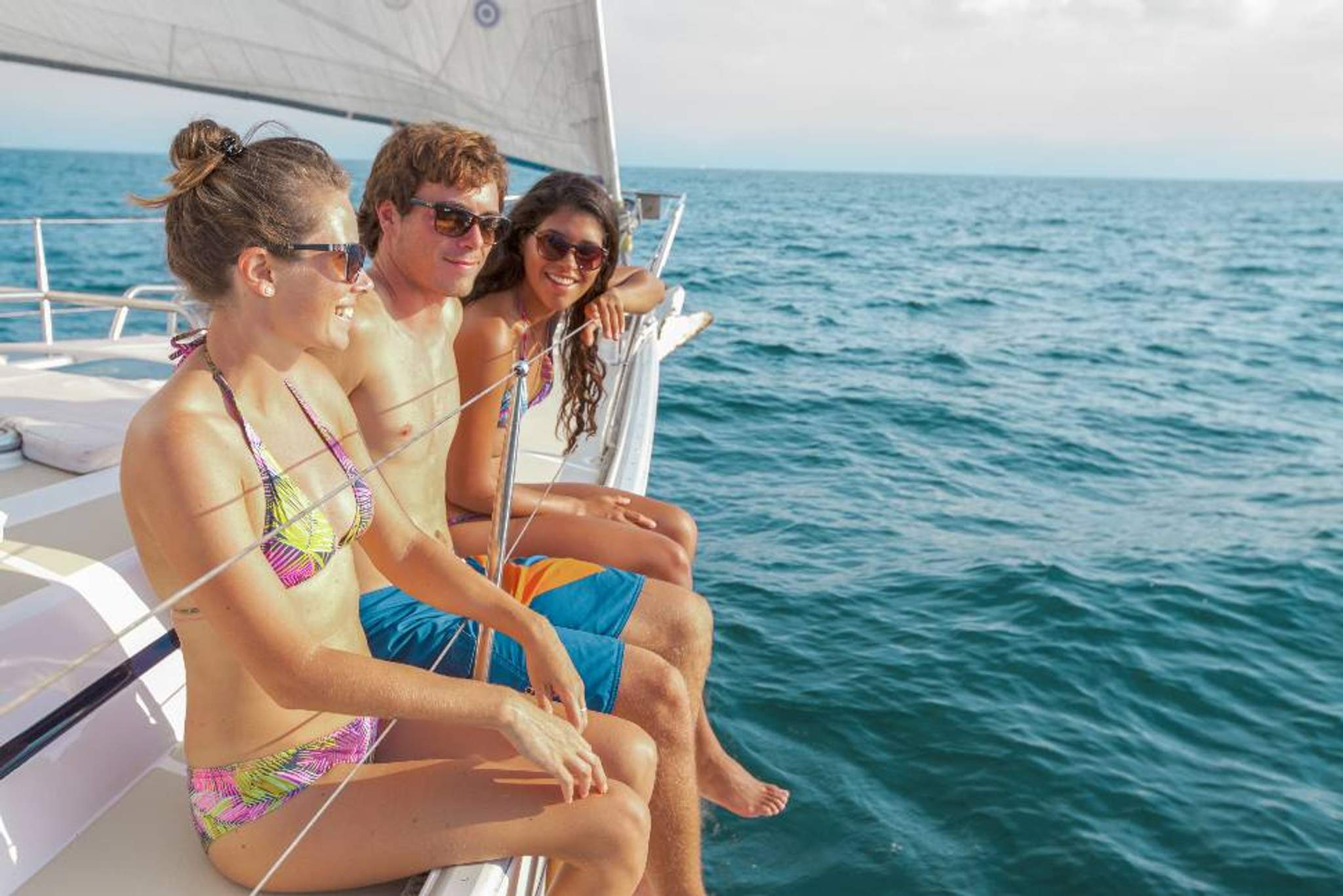Friends relaxing on a sailboat in the warm Puerto Vallarta sunshine.