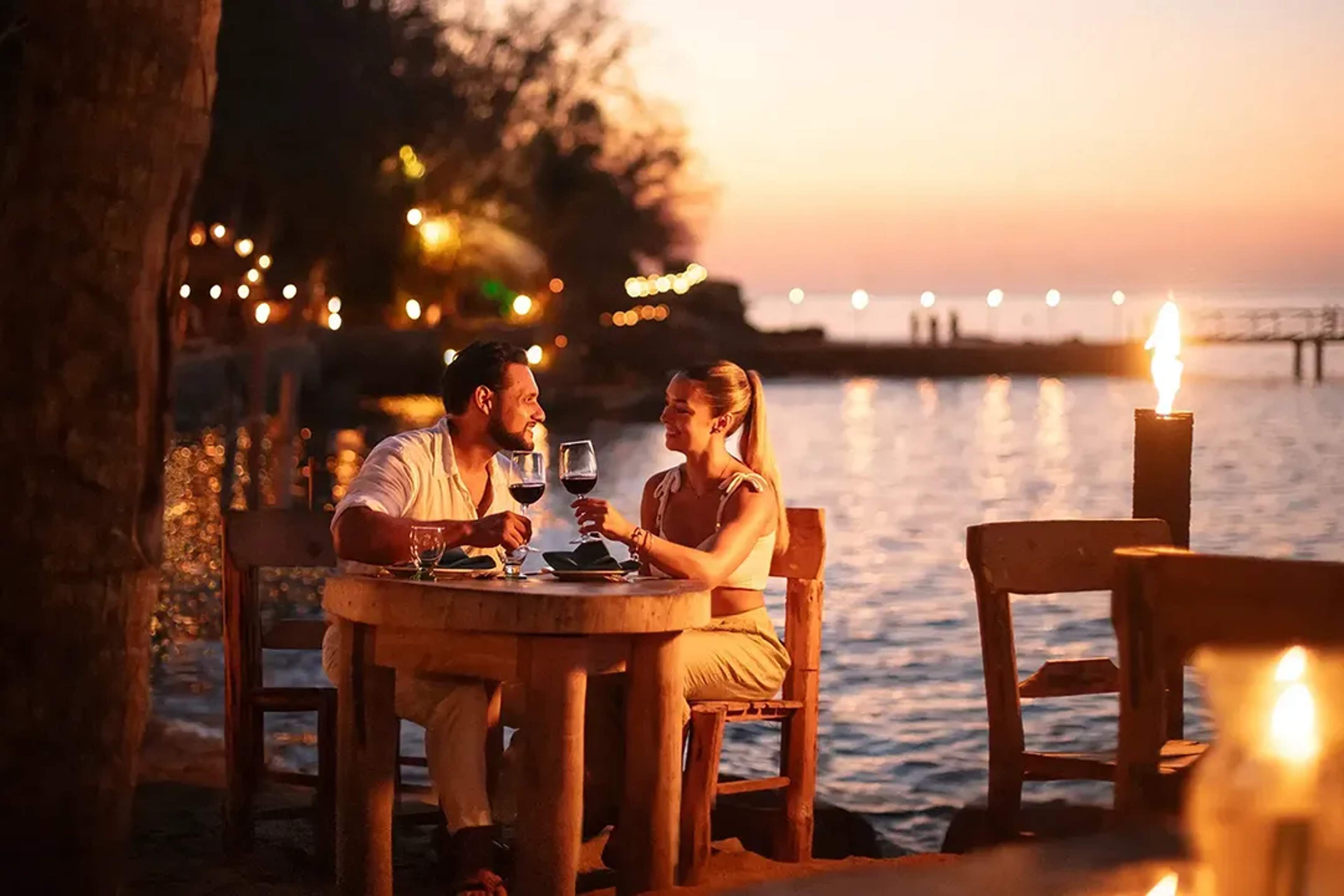 Romantic beachfront candlelight dinner at Rhythms of the Night in Puerto Vallarta, with ocean views at sunset!