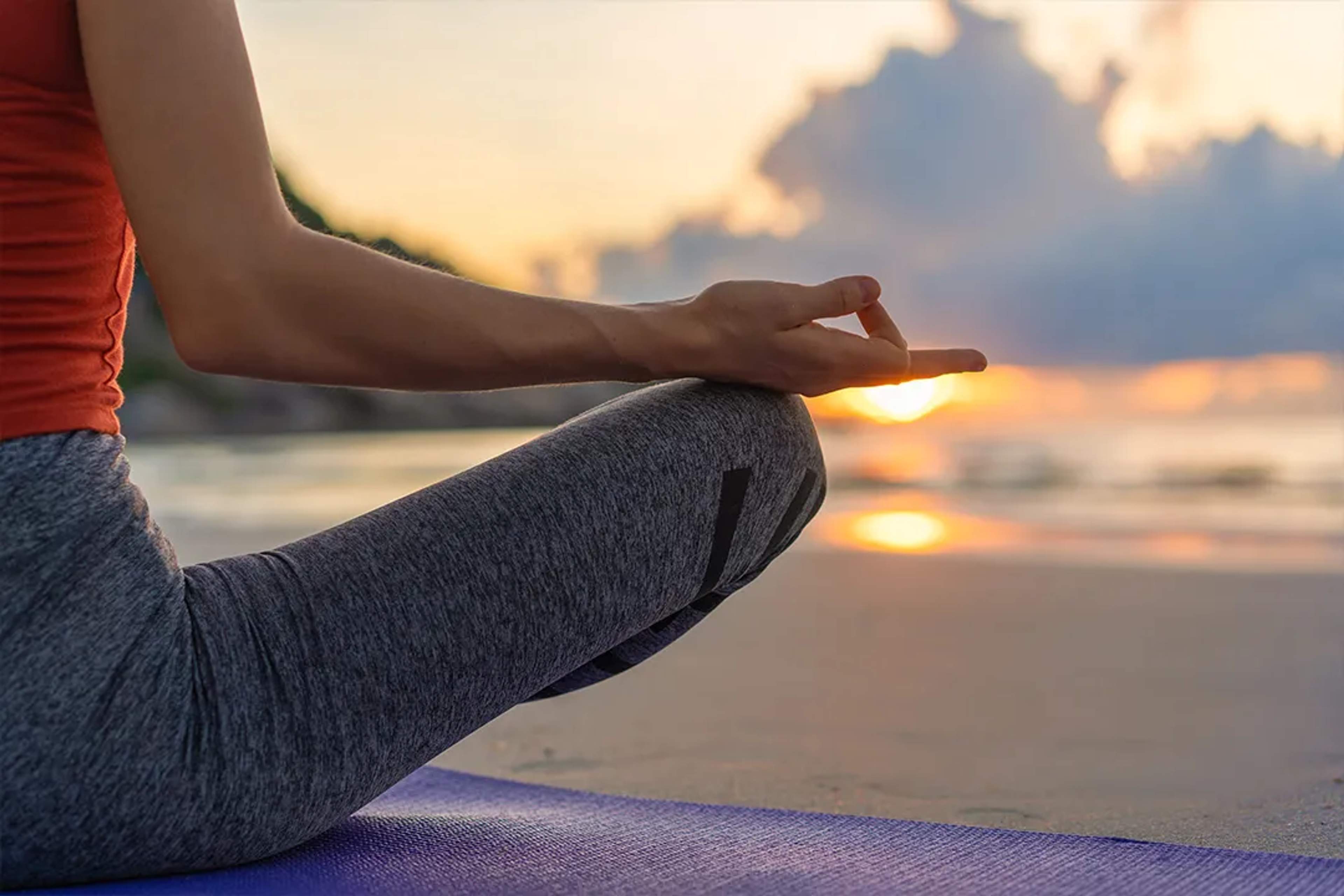 Sunset beach yoga session with peaceful meditation and ocean views.