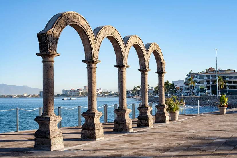 Iconic Los Arcos monument on Puerto Vallarta’s Malecón with ocean views and colonial charm.