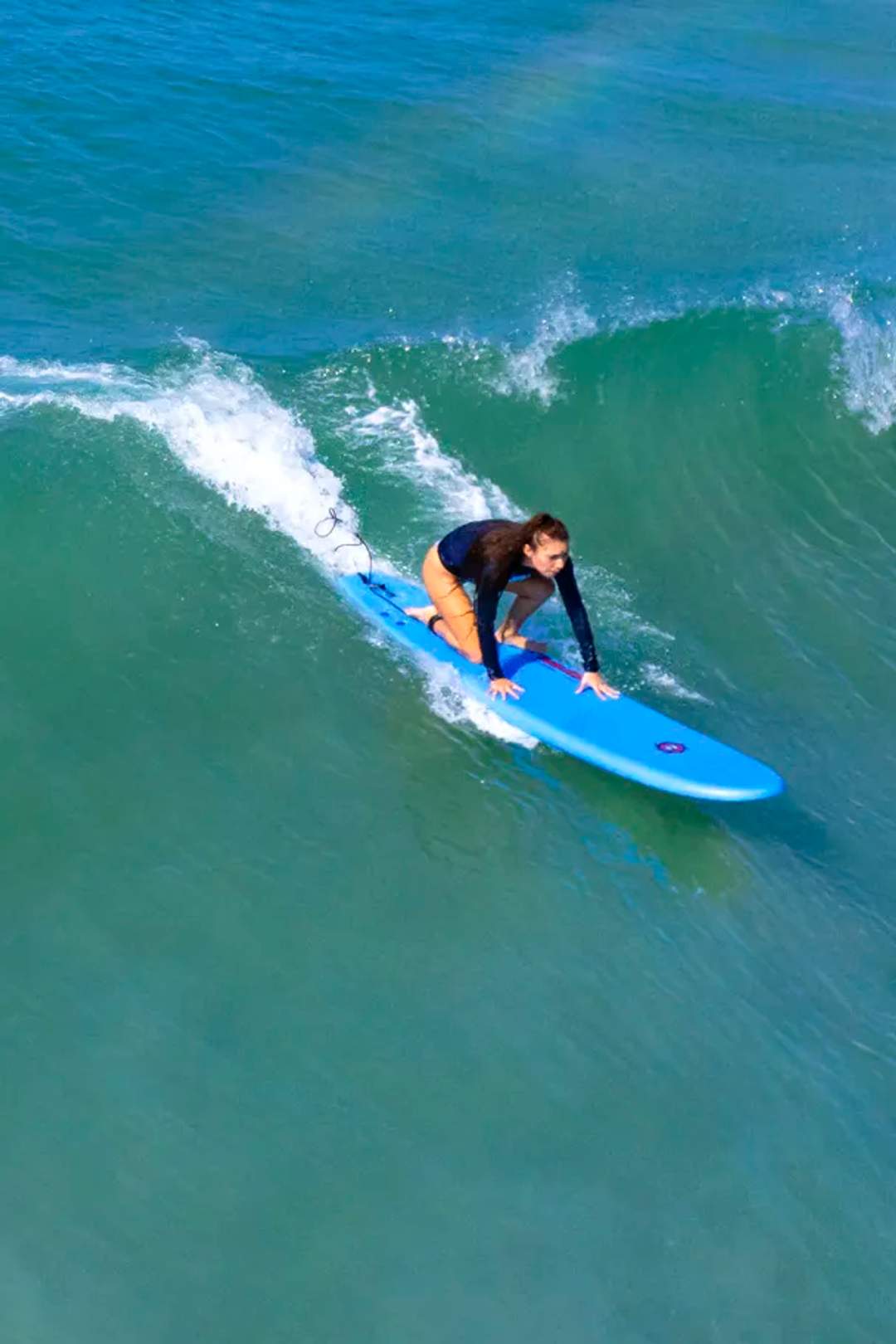 Private Surf Lesson in Punta Mita with instructor helping beginner ride a Pacific wave.
