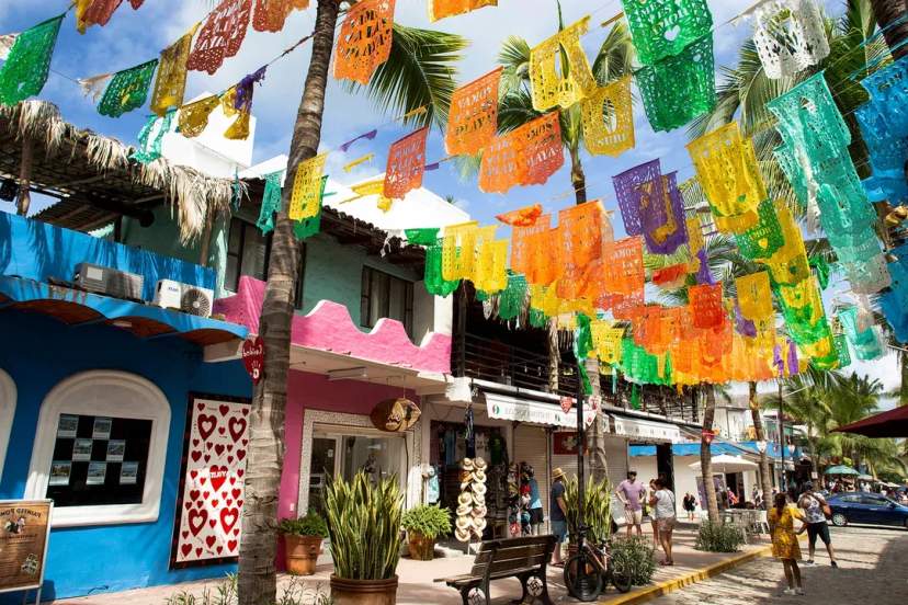 Colorful papel picado in Sayulita’s vibrant streets, Mexico – tropical vibes and local charm.