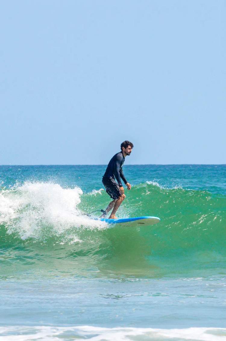 Surfer riding a Pacific wave during a private surf lesson in Punta Mita, Riviera Nayarit.