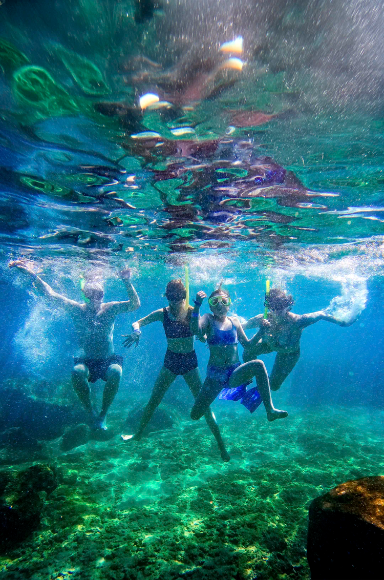 Children snorkeling at Las Caletas, one of the best Puerto Vallarta family beaches.