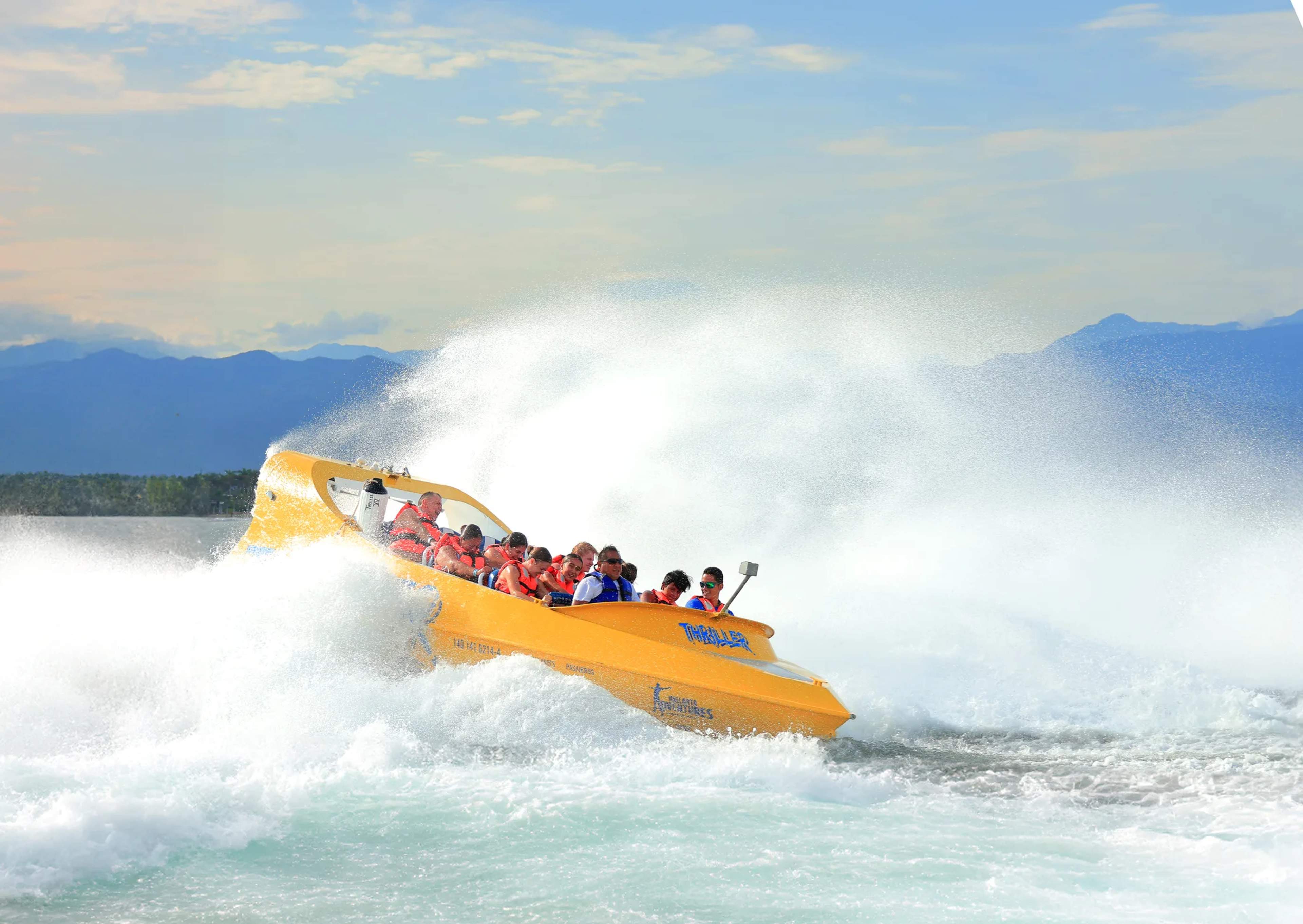Bright yellow speedboat packed with passengers crashes through large ocean waves on a thrilling water adventure off the