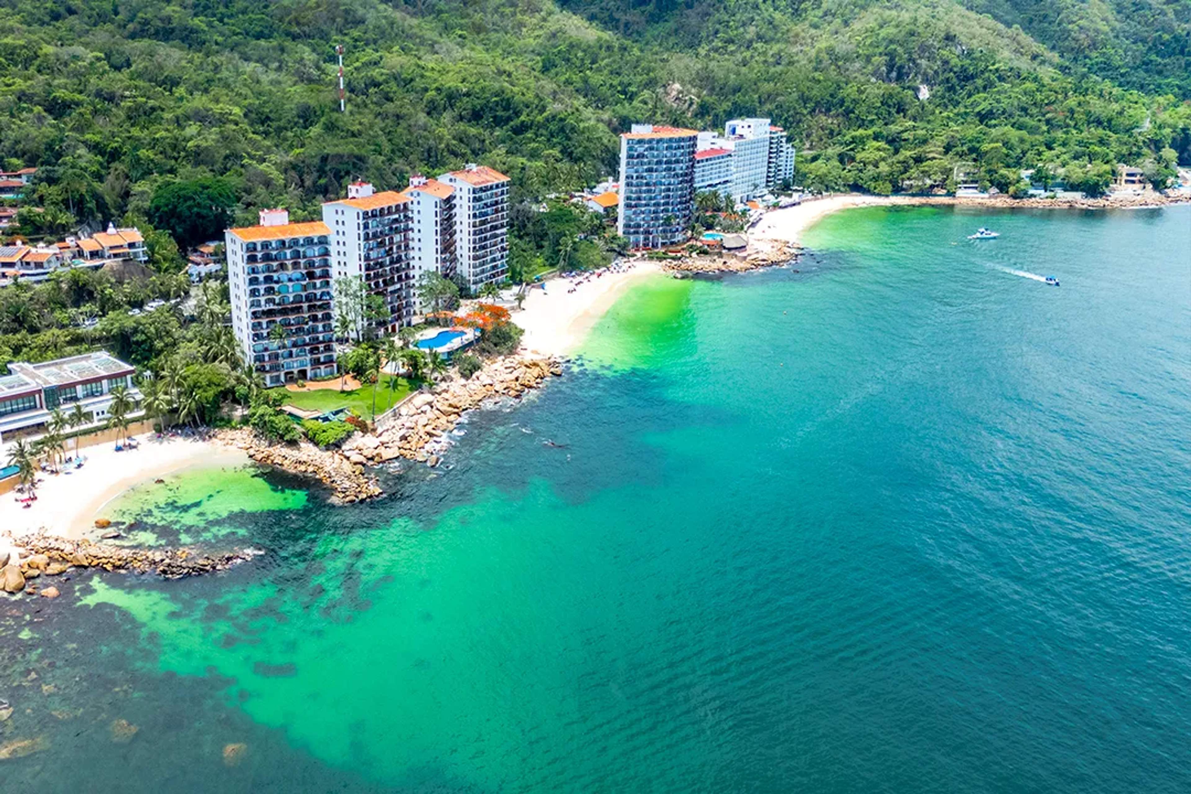 Aerial view of Las Gemelas Beach in Puerto Vallarta with turquoise water and jungle coastline