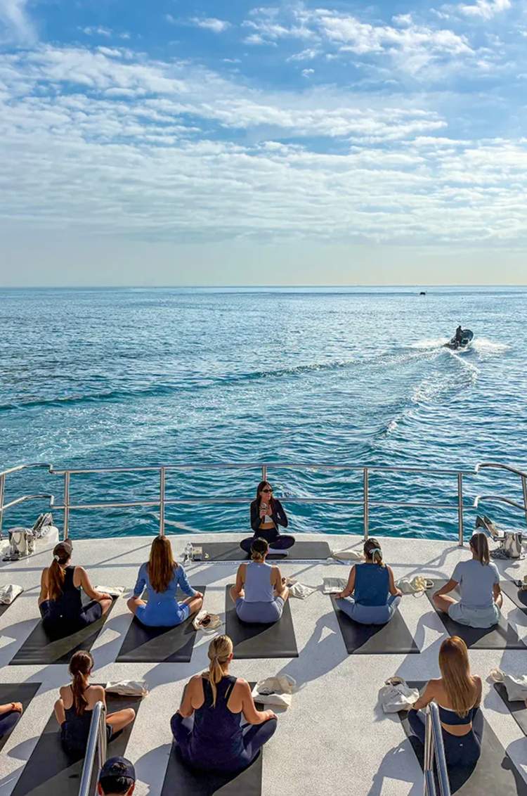 Private yoga session aboard Seventeen premium catamaran overlooking the ocean in Puerto Vallarta.