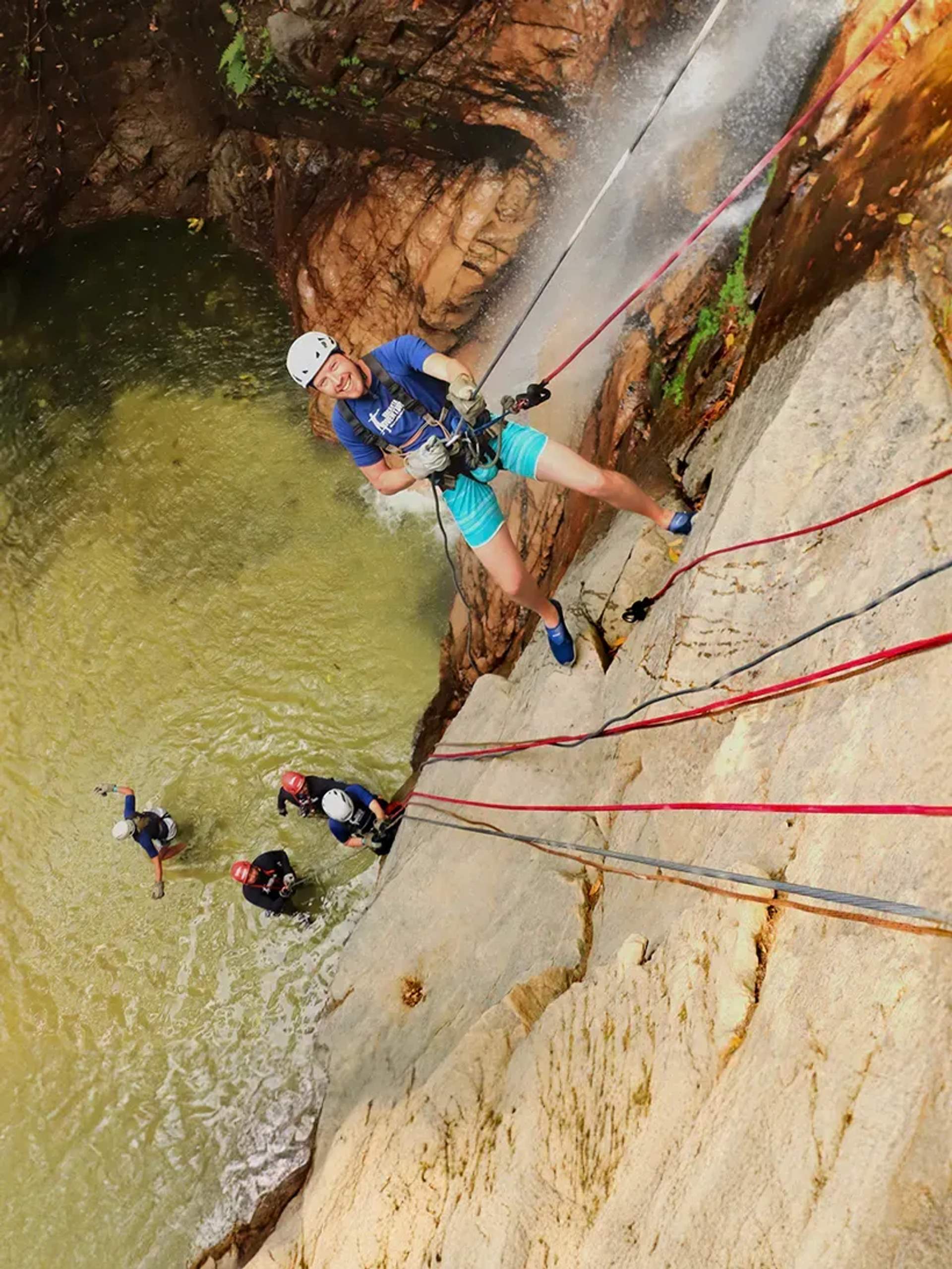 Rappelling down a stunning waterfall into a jungle pool—pure adrenaline and adventure in paradise!
