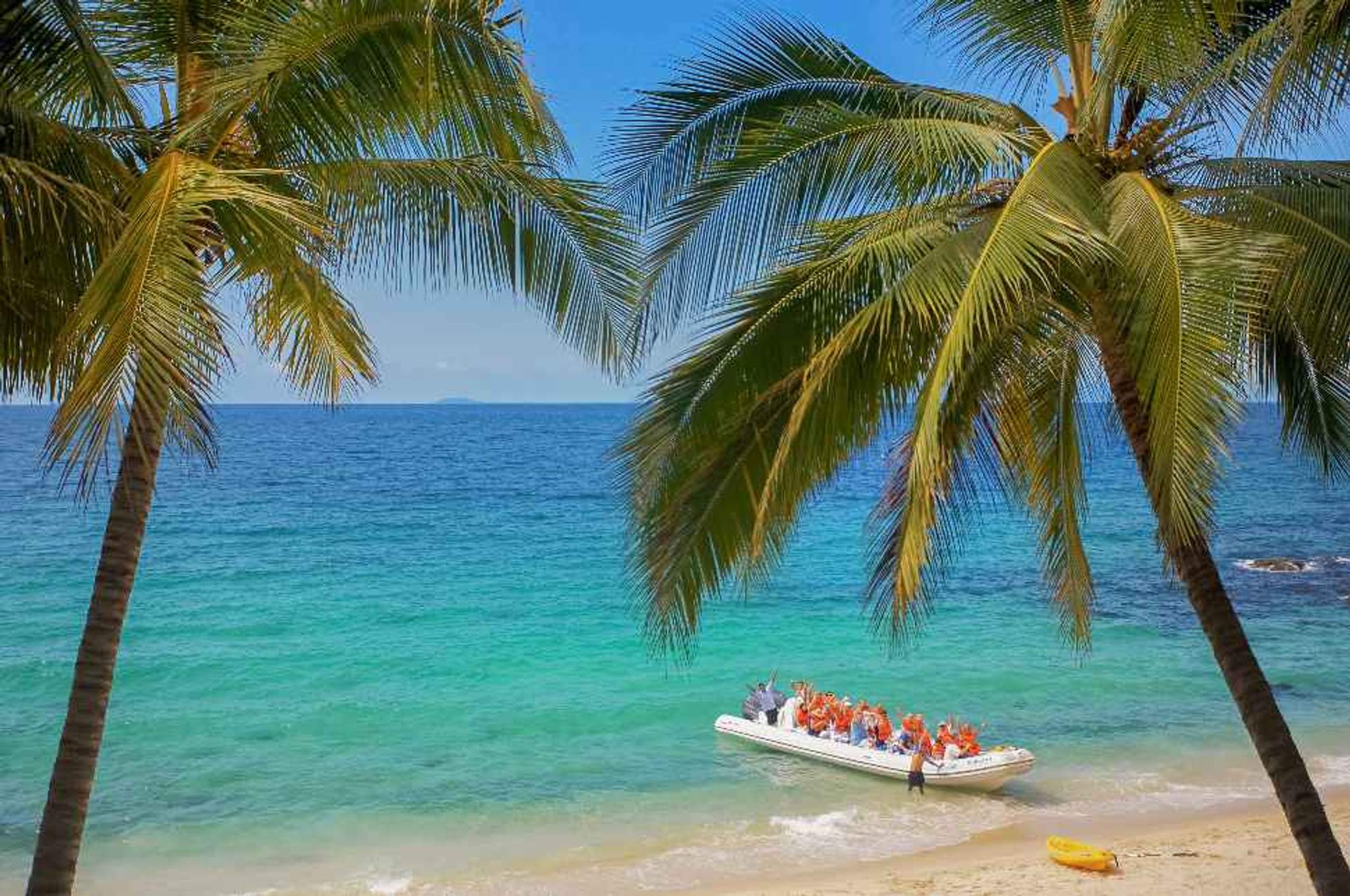 Tourists arriving on a boat at a secluded beach in Puerto Vallarta.