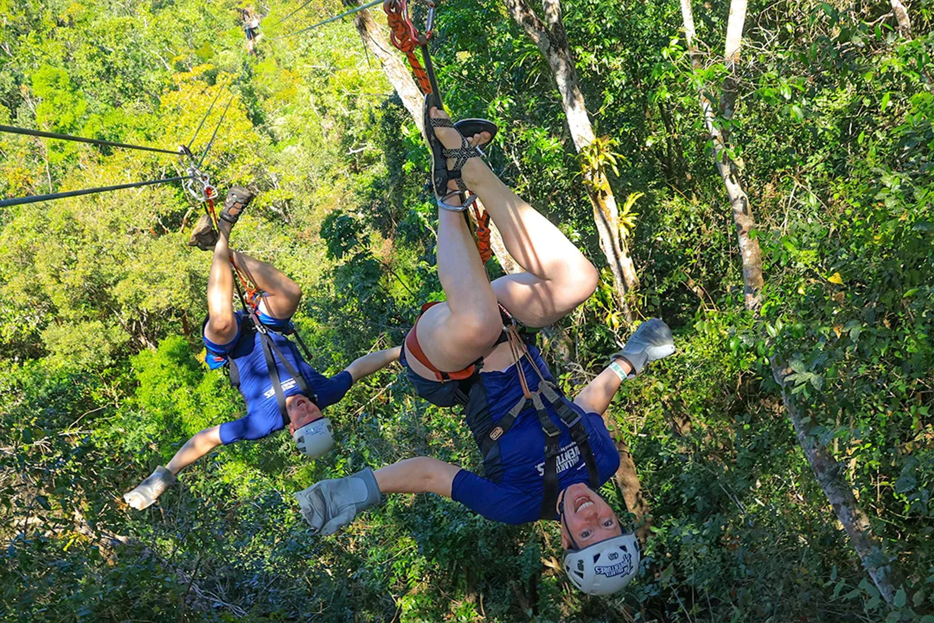 Guests zip-lining upside down through Puerto Vallarta jungle on Outdoor Adventure tour in Sierra Madre canopy