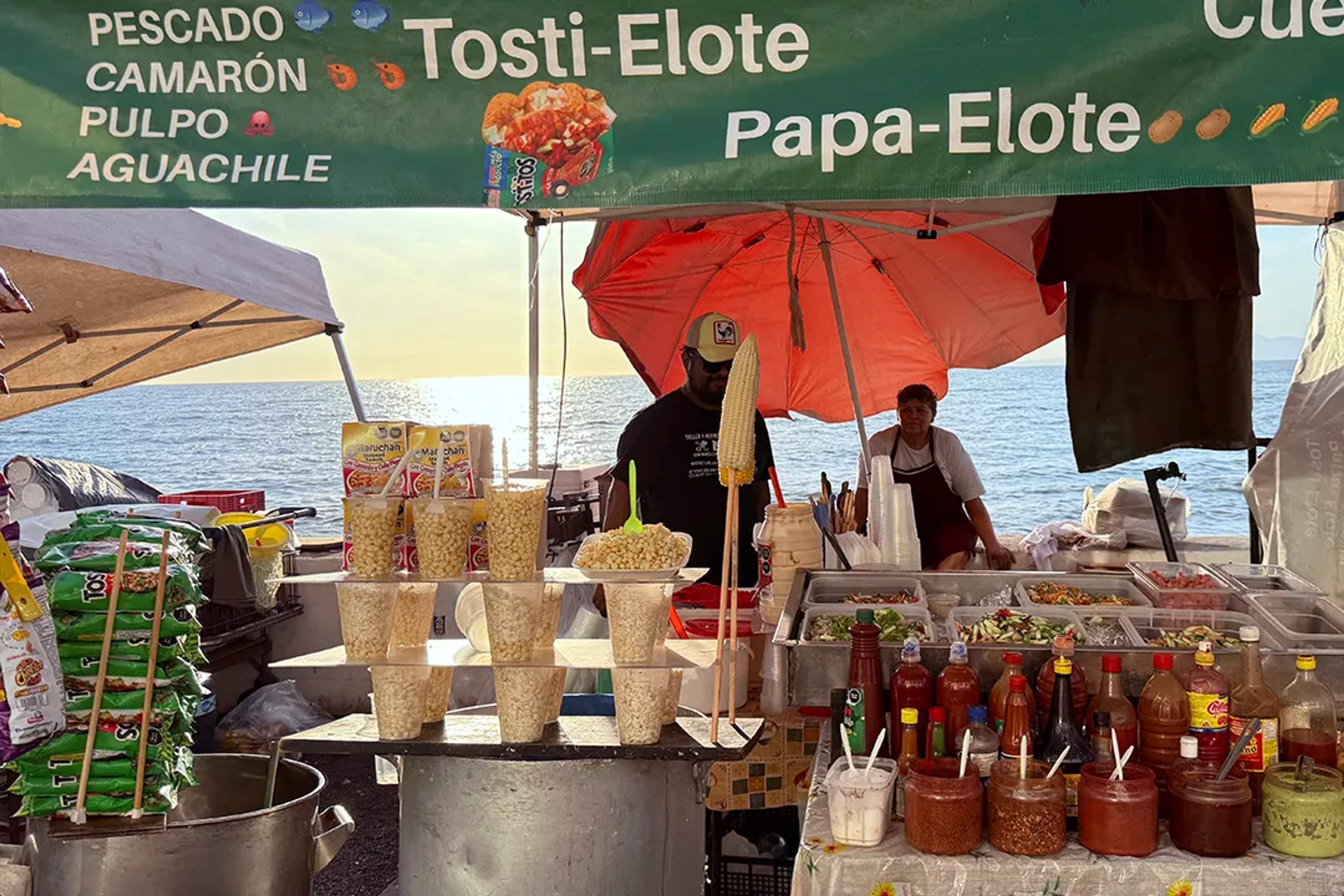 Beach elote stand in Puerto Vallarta, authentic Mexican street food experience.