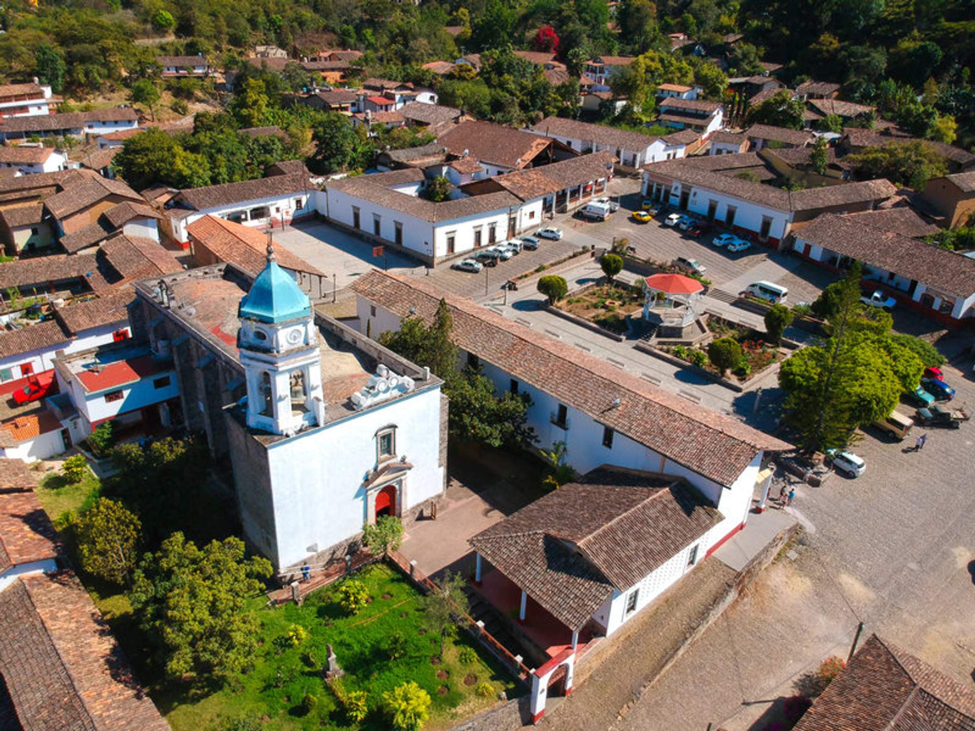 Aerial view of San Sebastian del Oeste, showcasing its charming colonial architecture and central plaza surrounded by lush greenery.