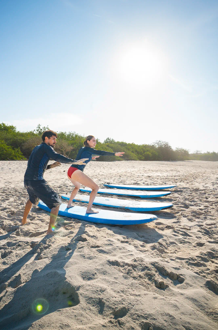 Private surf lesson in Punta Mita with instructor teaching surfing fundamentals before entering the ocean
