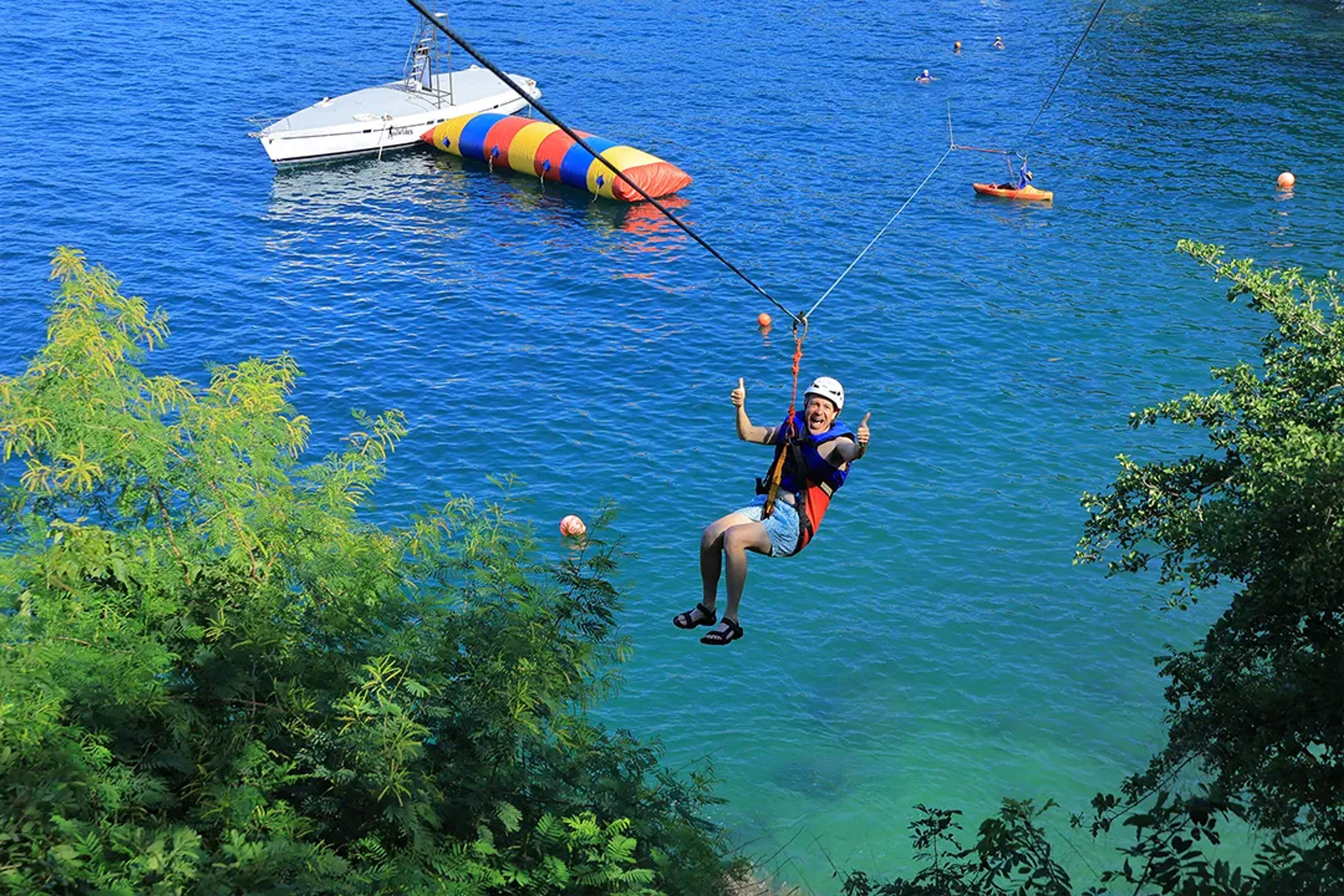 Person ziplining over the ocean during the Ocean Mania adventure tour in Puerto Vallarta, Mexico