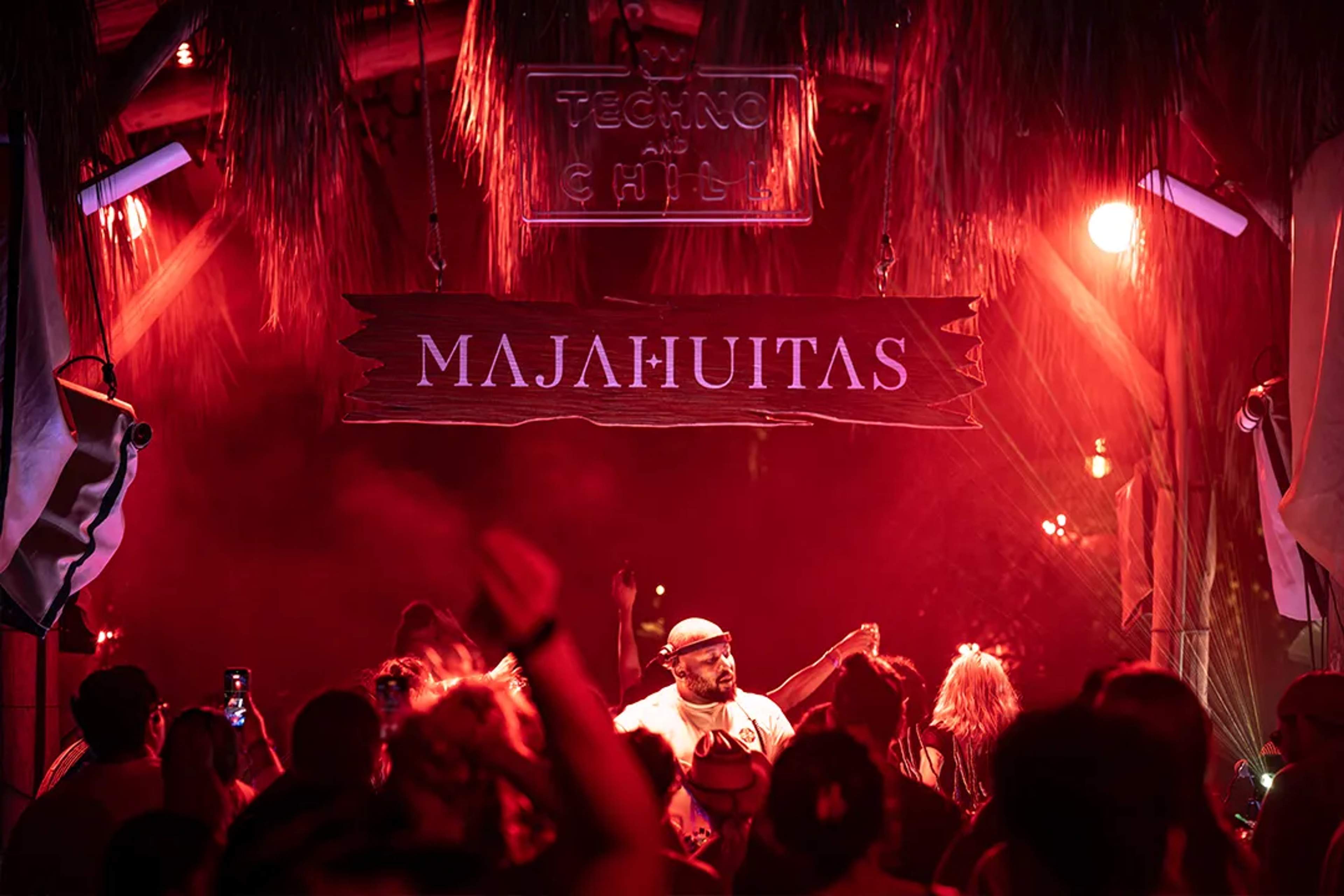 Night party at Majahuitas Beach Club in Puerto Vallarta with DJ set and vibrant red lights.
