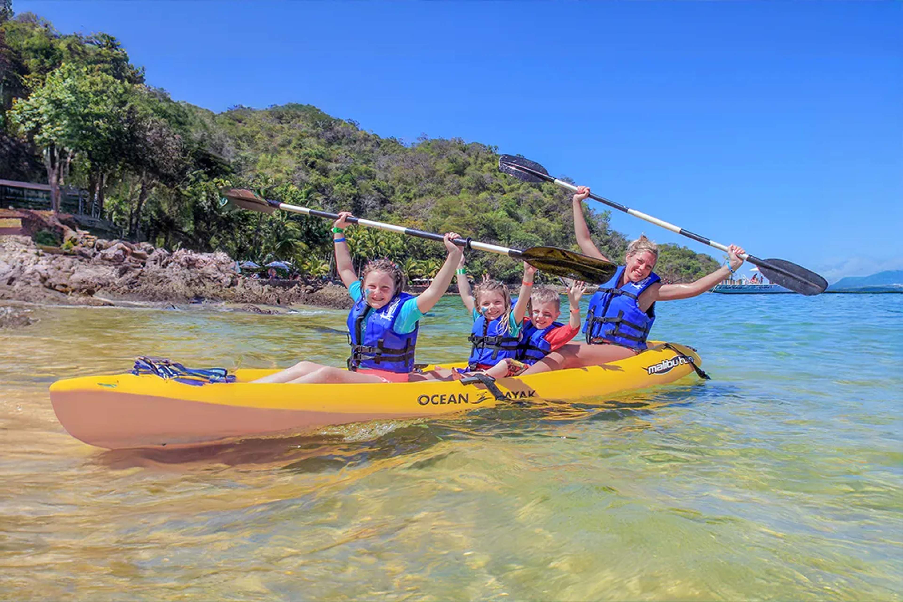 Family kayaking at Las Caletas in Puerto Vallarta with clear water and jungle backdrop