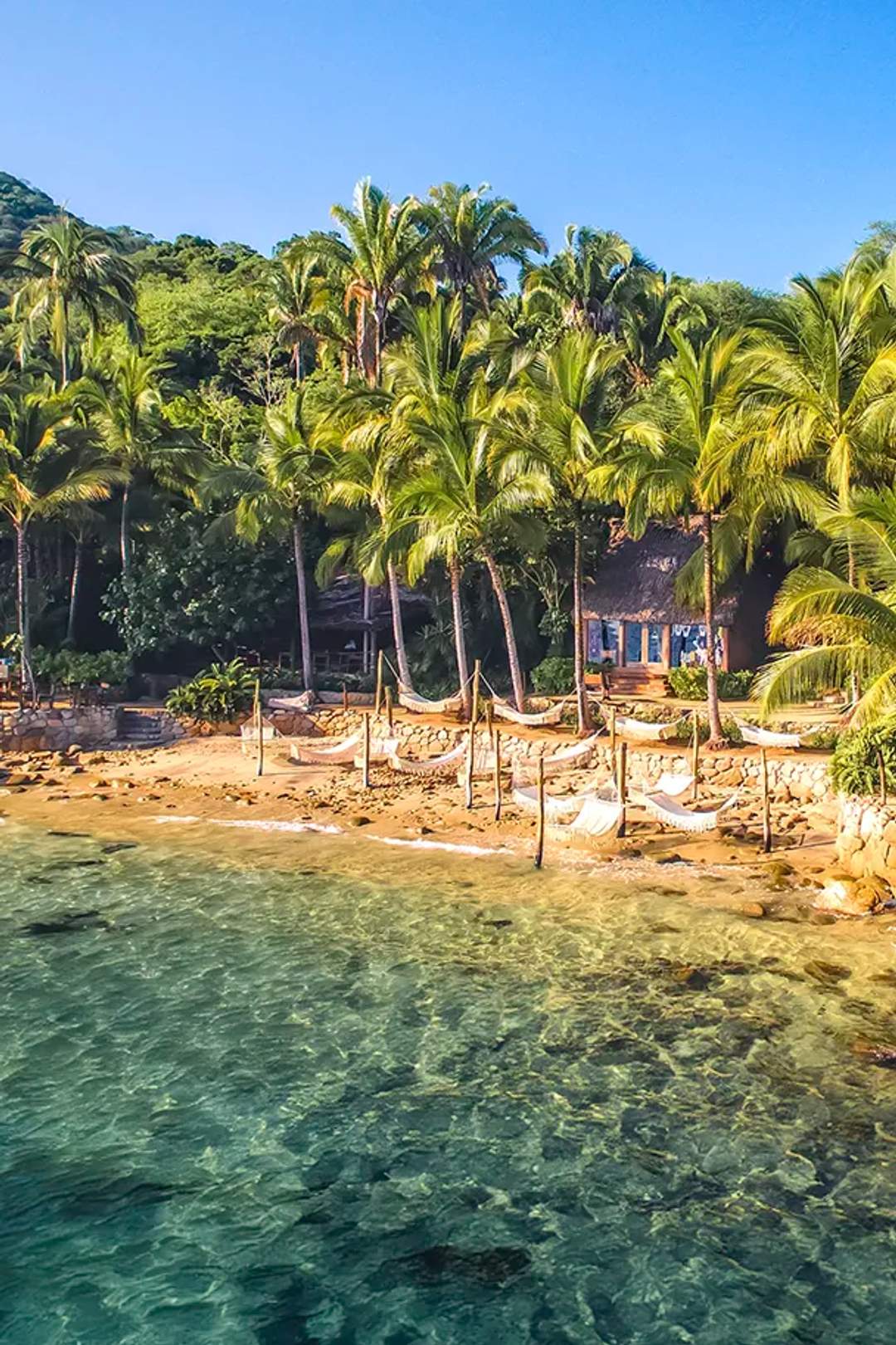 Beautiful view of Las Caletas beach with its iconic hammocks over the waves.