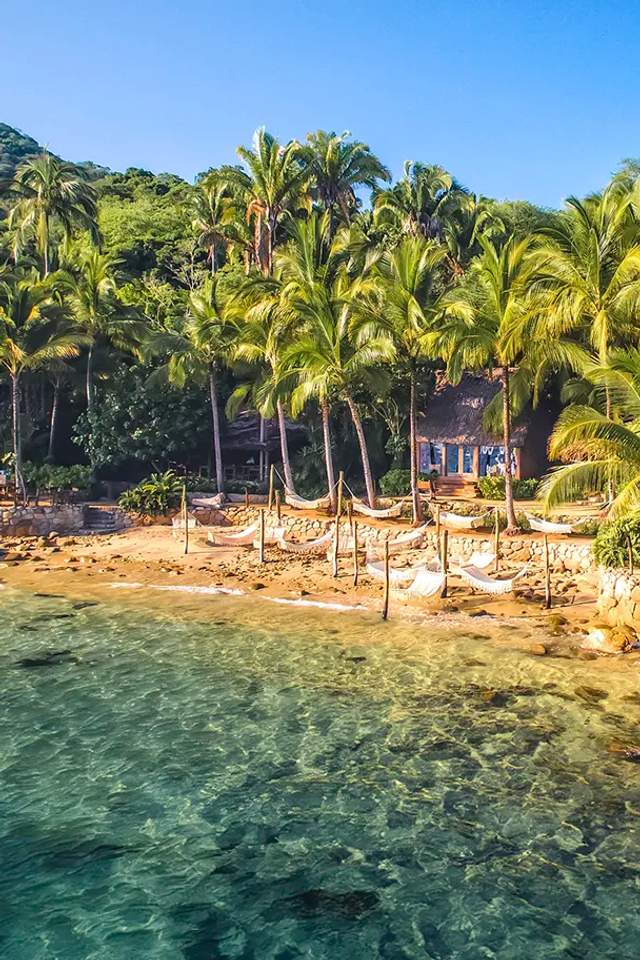 Beautiful view of Las Caletas beach with its iconic hammocks over the waves.