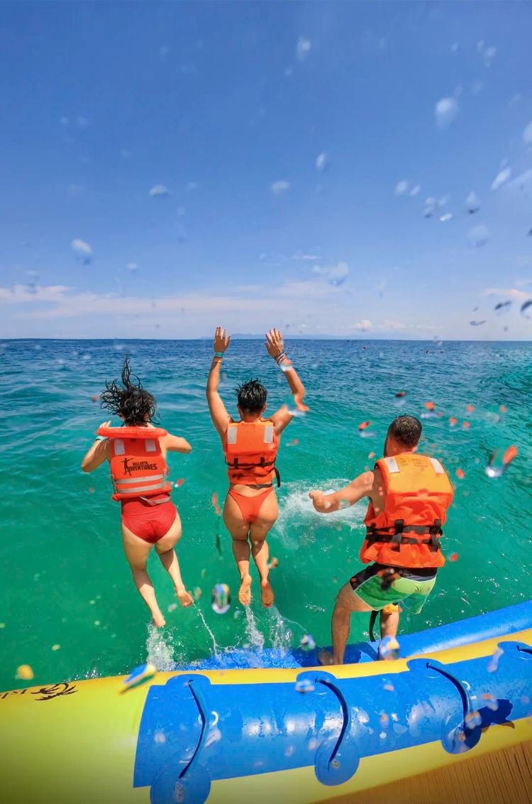 Friends jumping into the ocean at Puerto Vallarta's most fun water park.