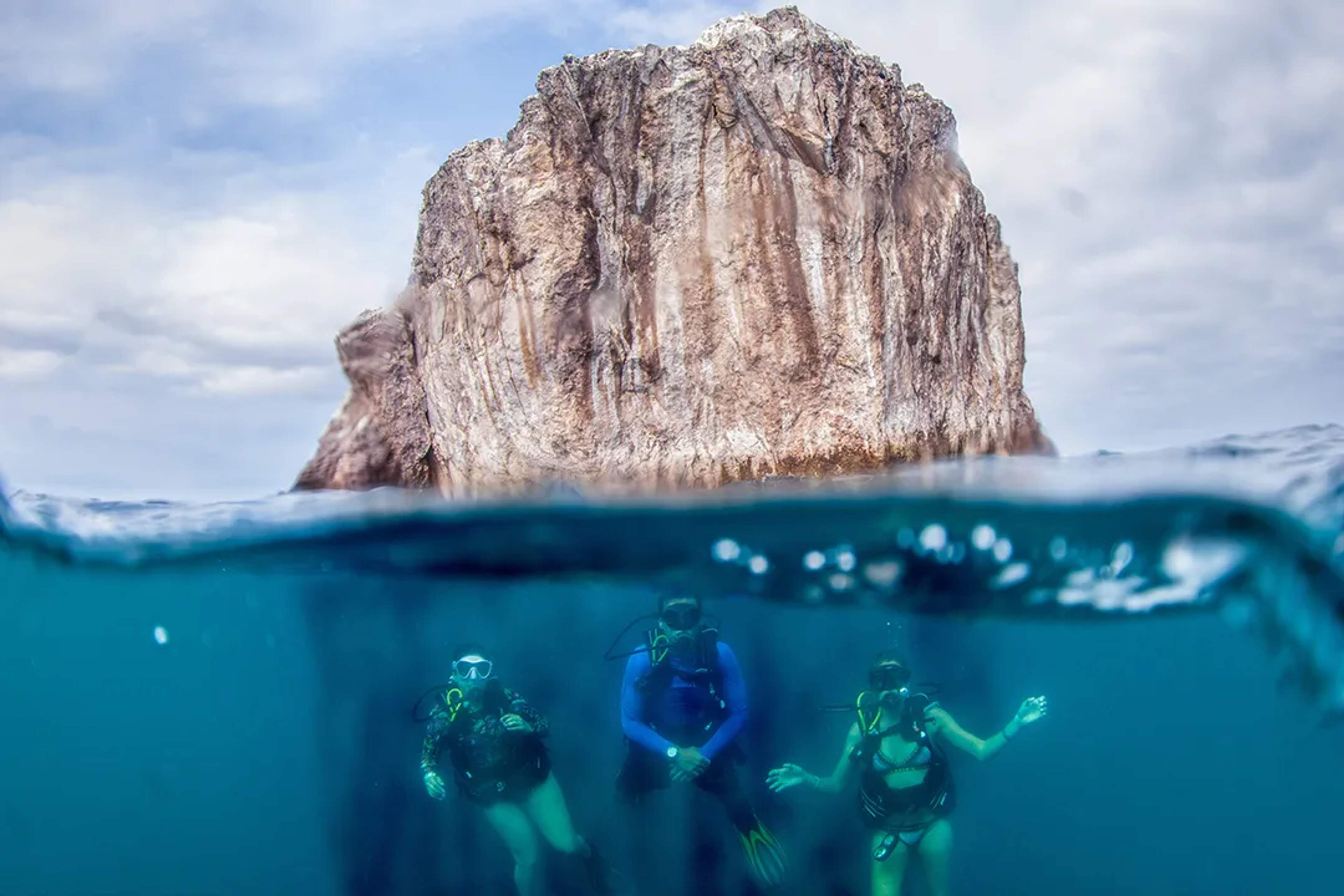 Scuba divers explore beneath the surface near El Morro’s towering rock formation in Puerto Vallarta.
