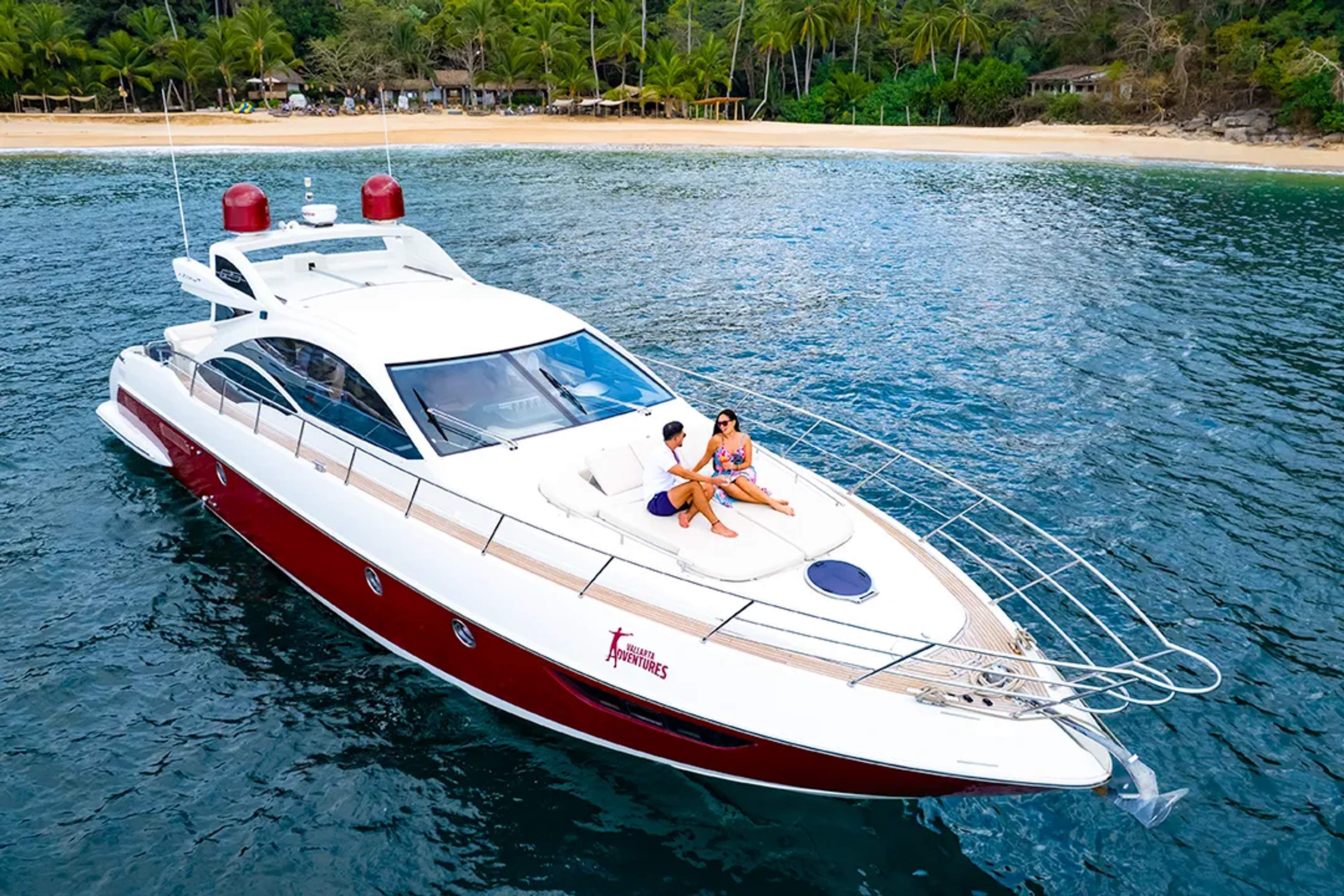 Private luxury yacht tour in Puerto Vallarta with couple cruising along tropical coastline