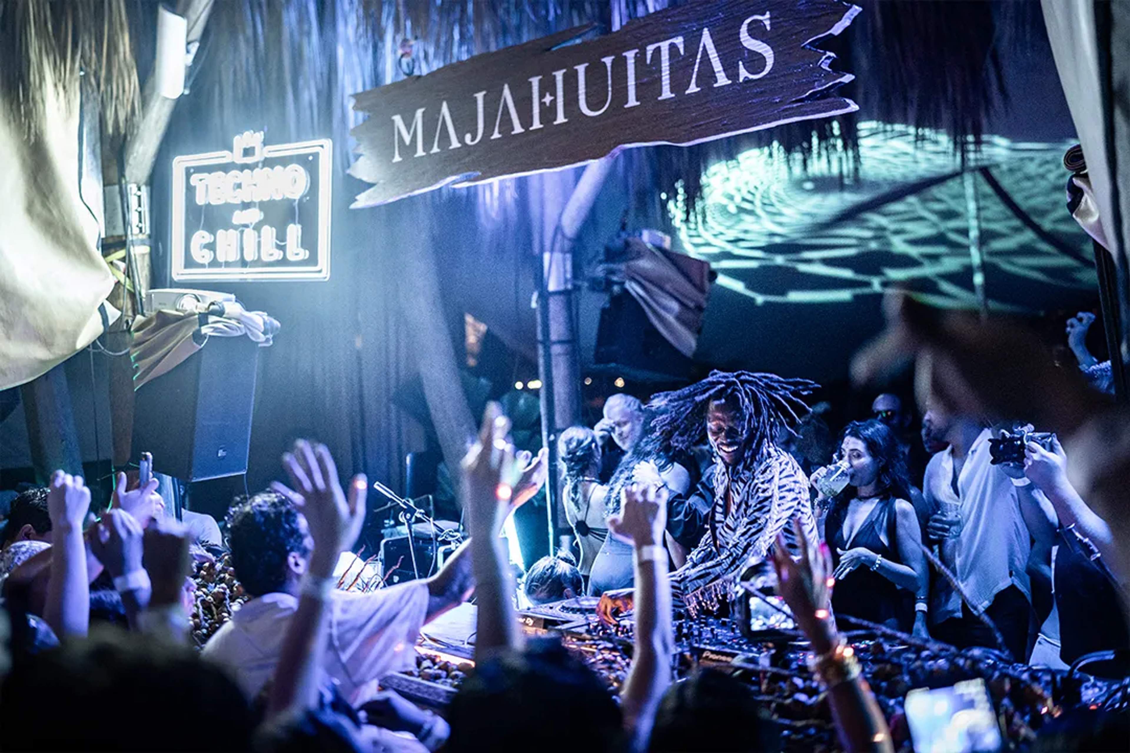 Majahuitas beach party with DJ, tropical vibes, dancing crowd and immersive nightlife experience.