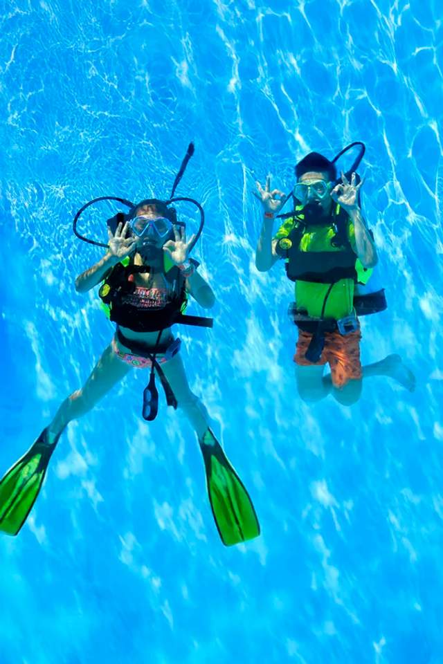 Kid learning to scuba dive, one the most fun activities for children in Puerto Vallarta.