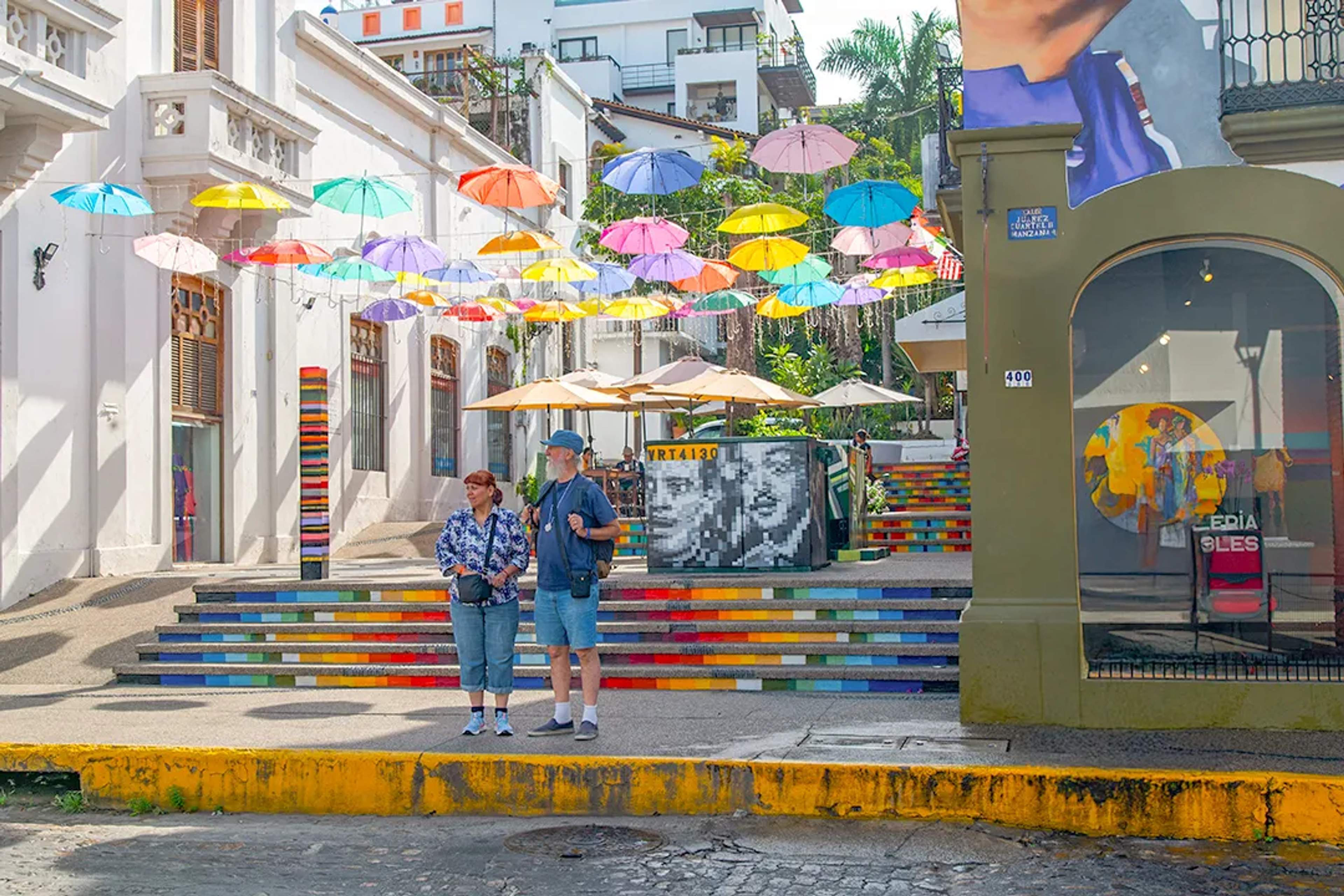 Colorful umbrella street in Puerto Vallarta Romantic Zone, vibrant art and cultural walking tour.